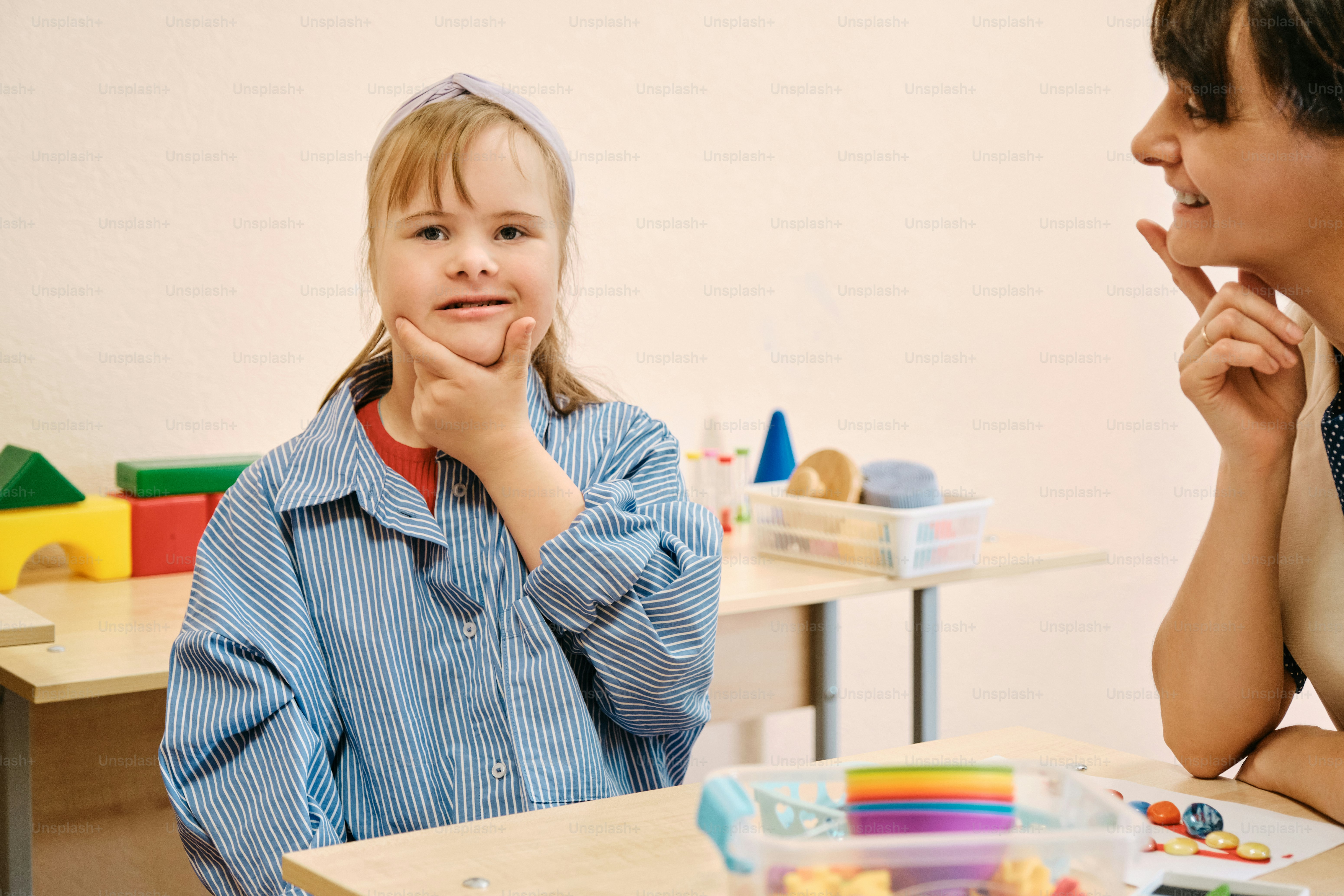 a woman and a little girl sitting at a table