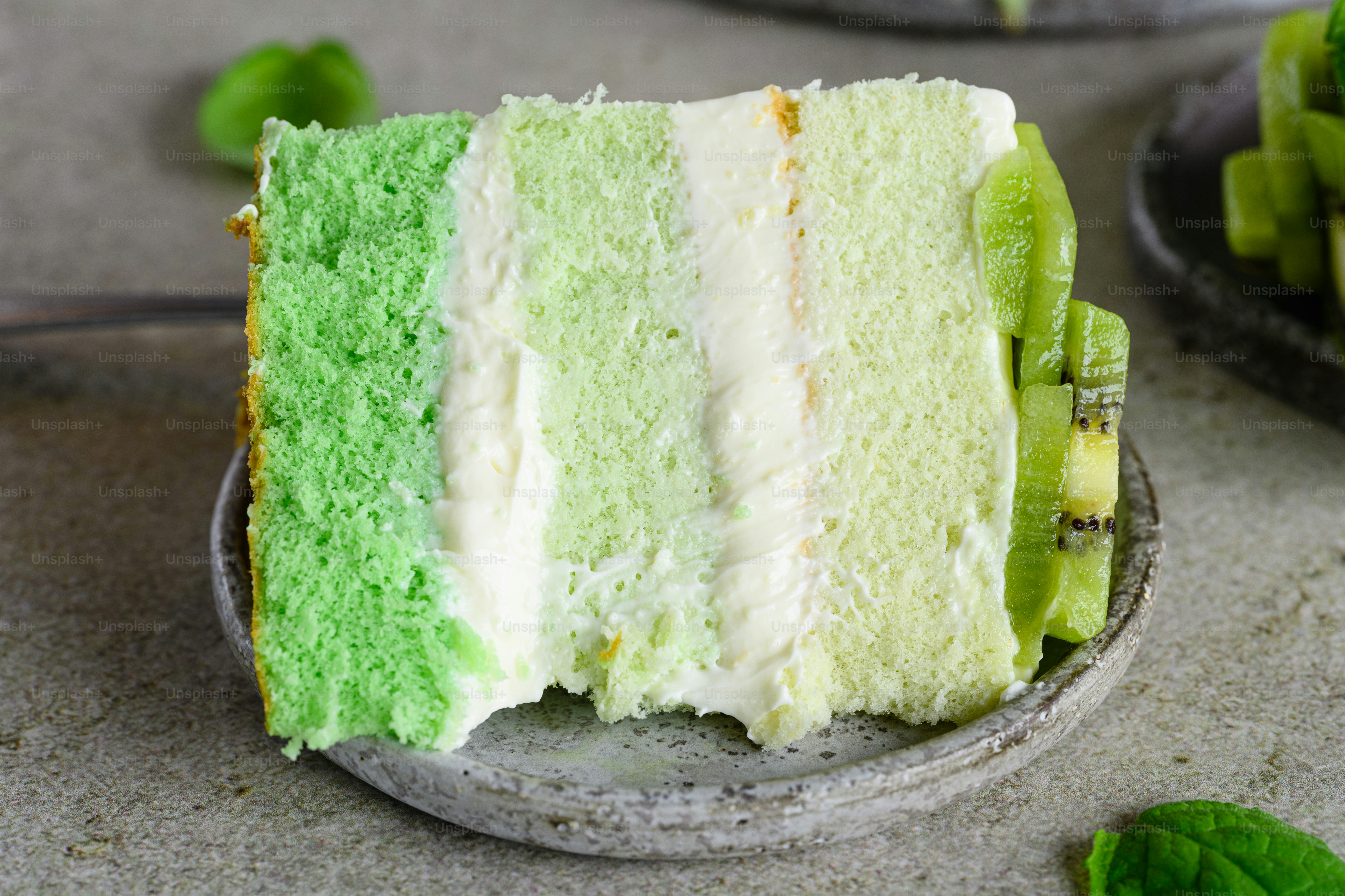 a slice of green cake on a plate