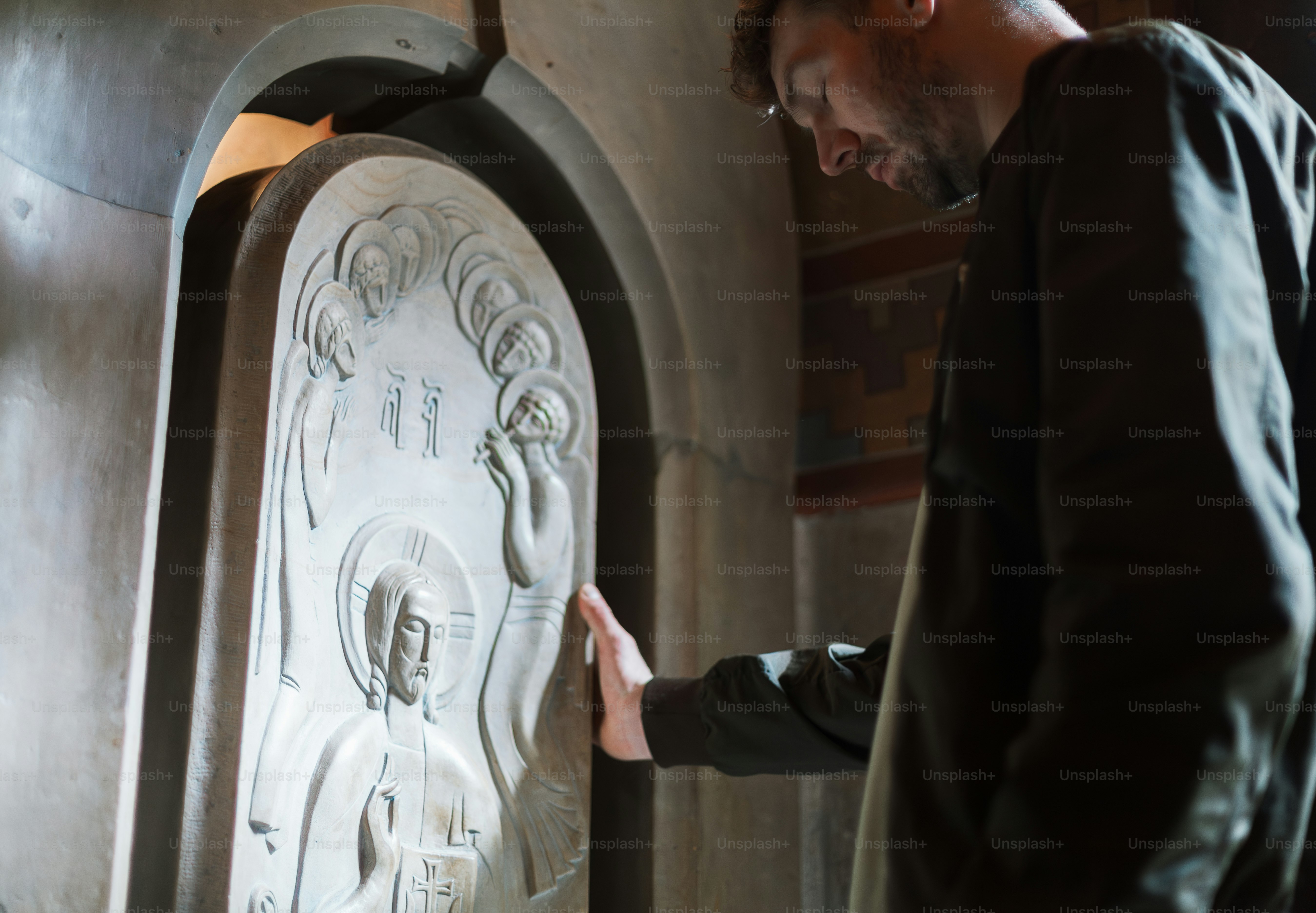 a man standing in front of a large clock