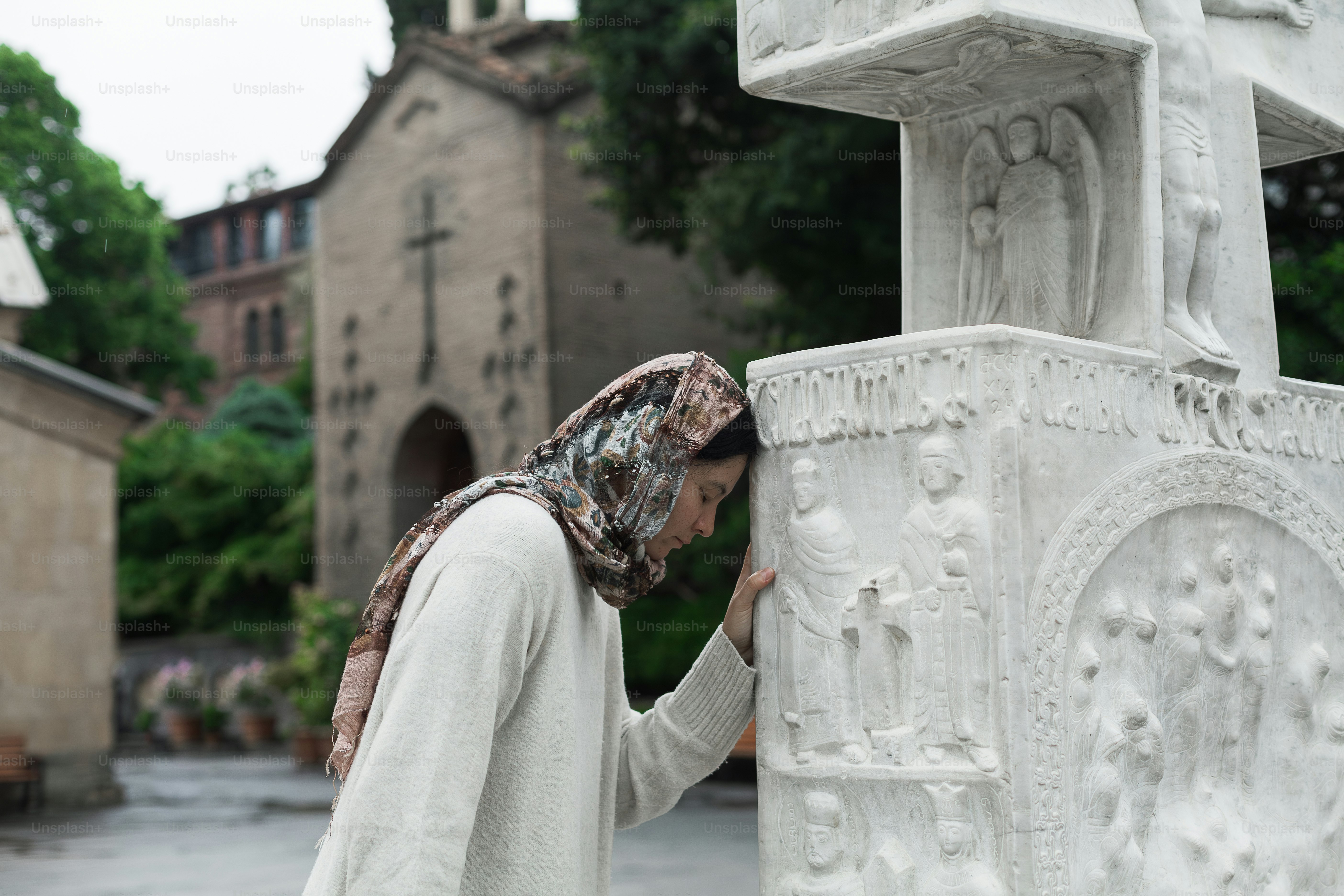 a woman standing next to a white statue