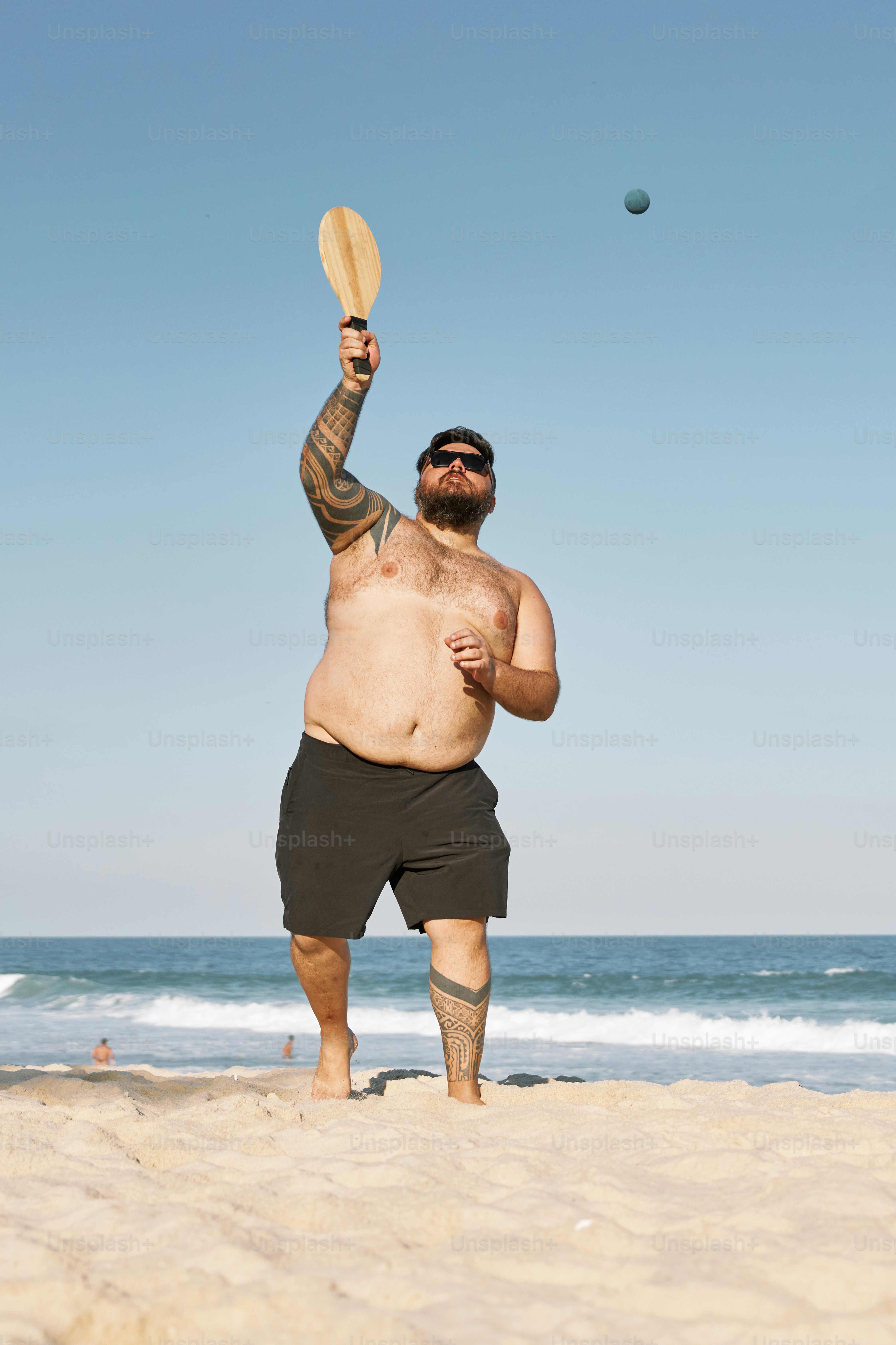a man on the beach throwing a frisbee