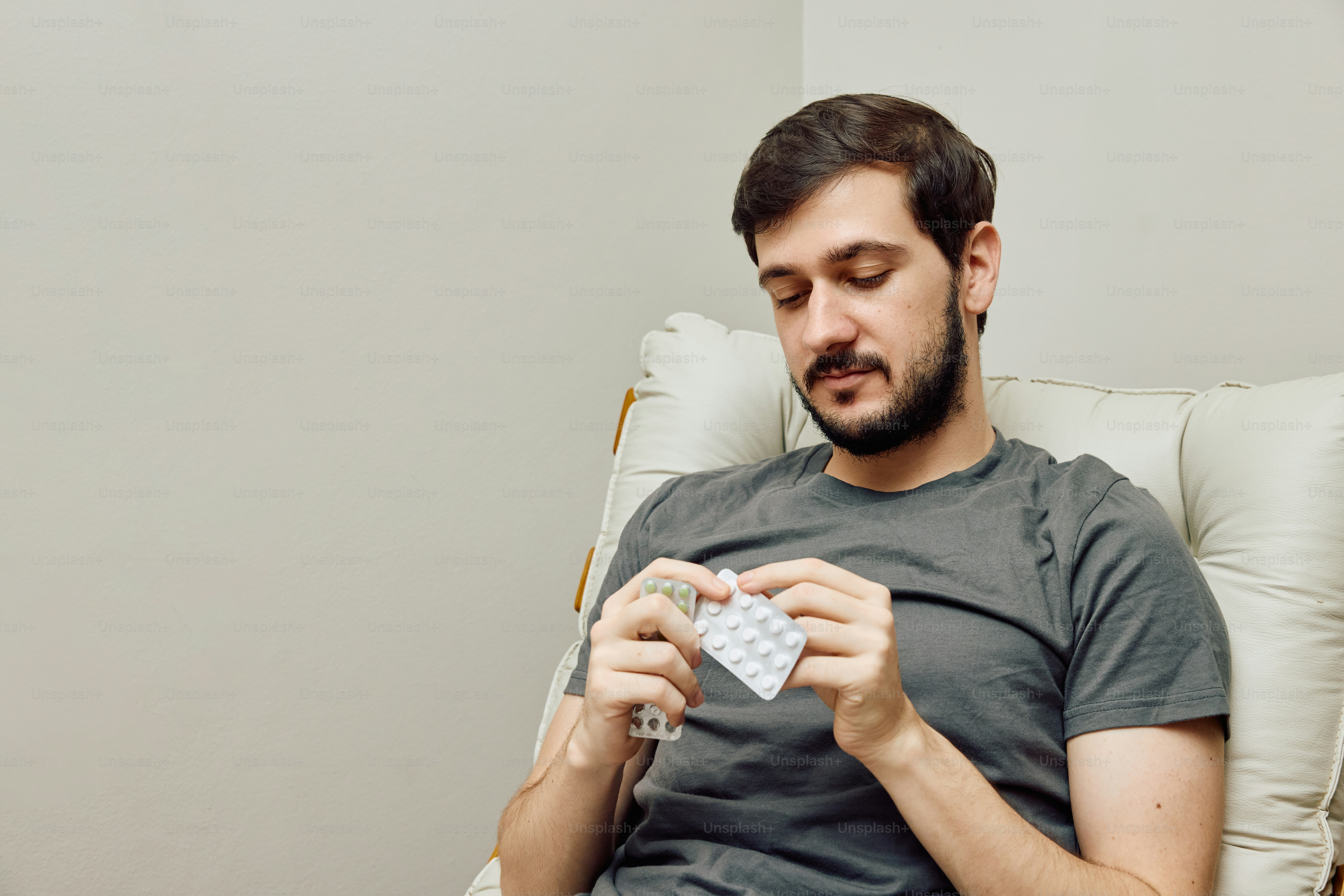 a man sitting in a chair holding a piece of paper