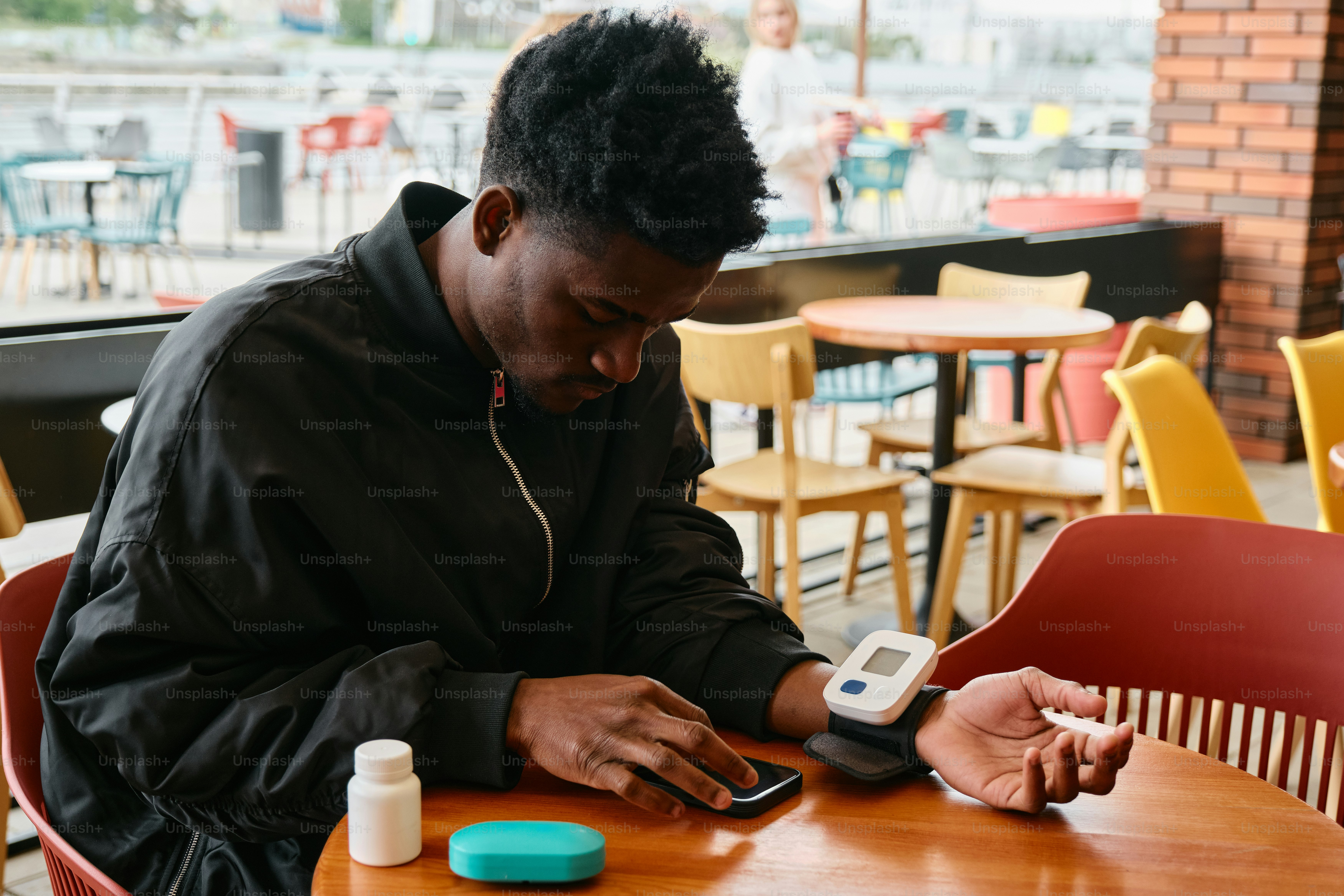 a man sitting at a table using a cell phone