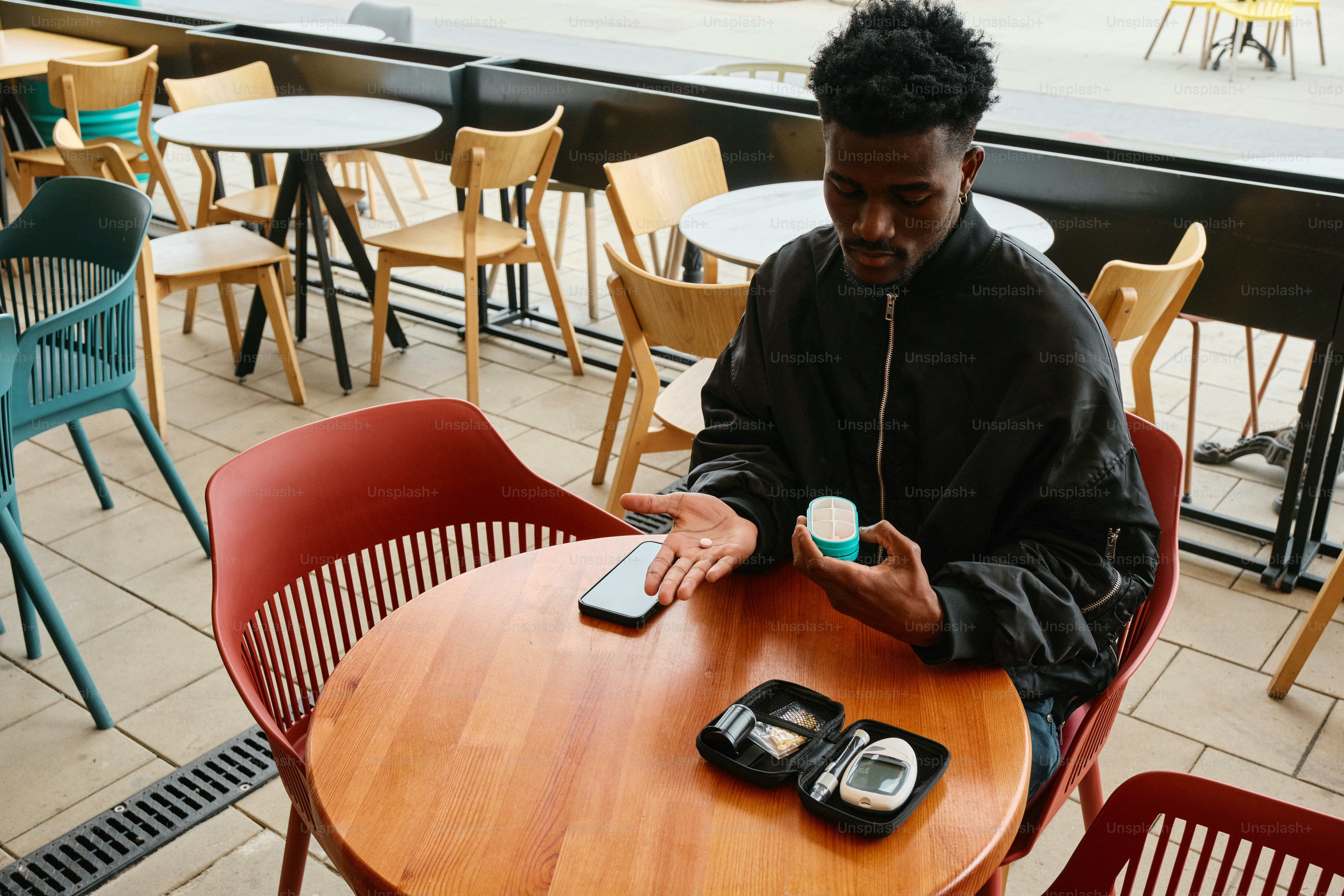 a man sitting at a table with a cell phone