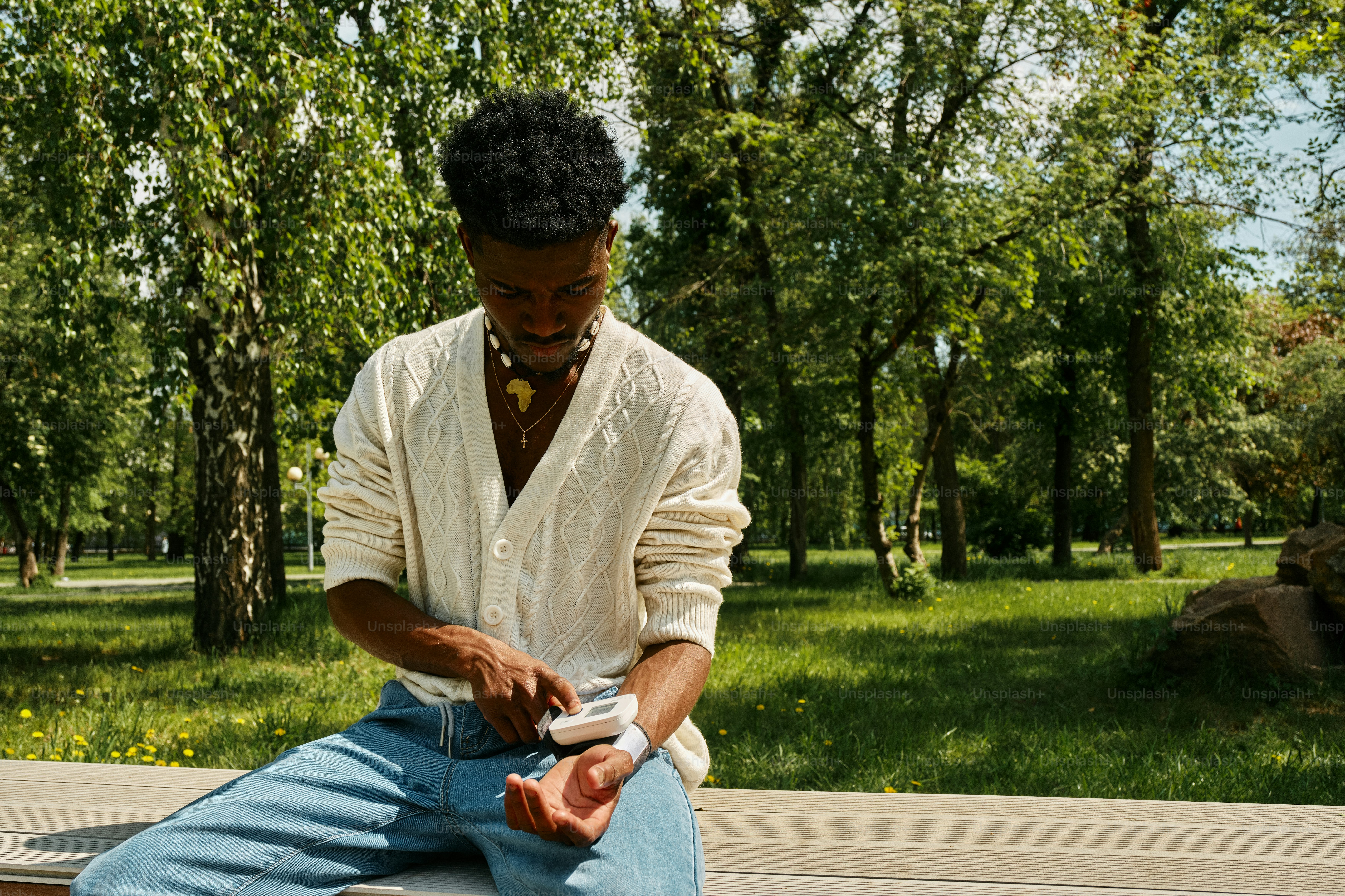 a man sitting on a bench in a park