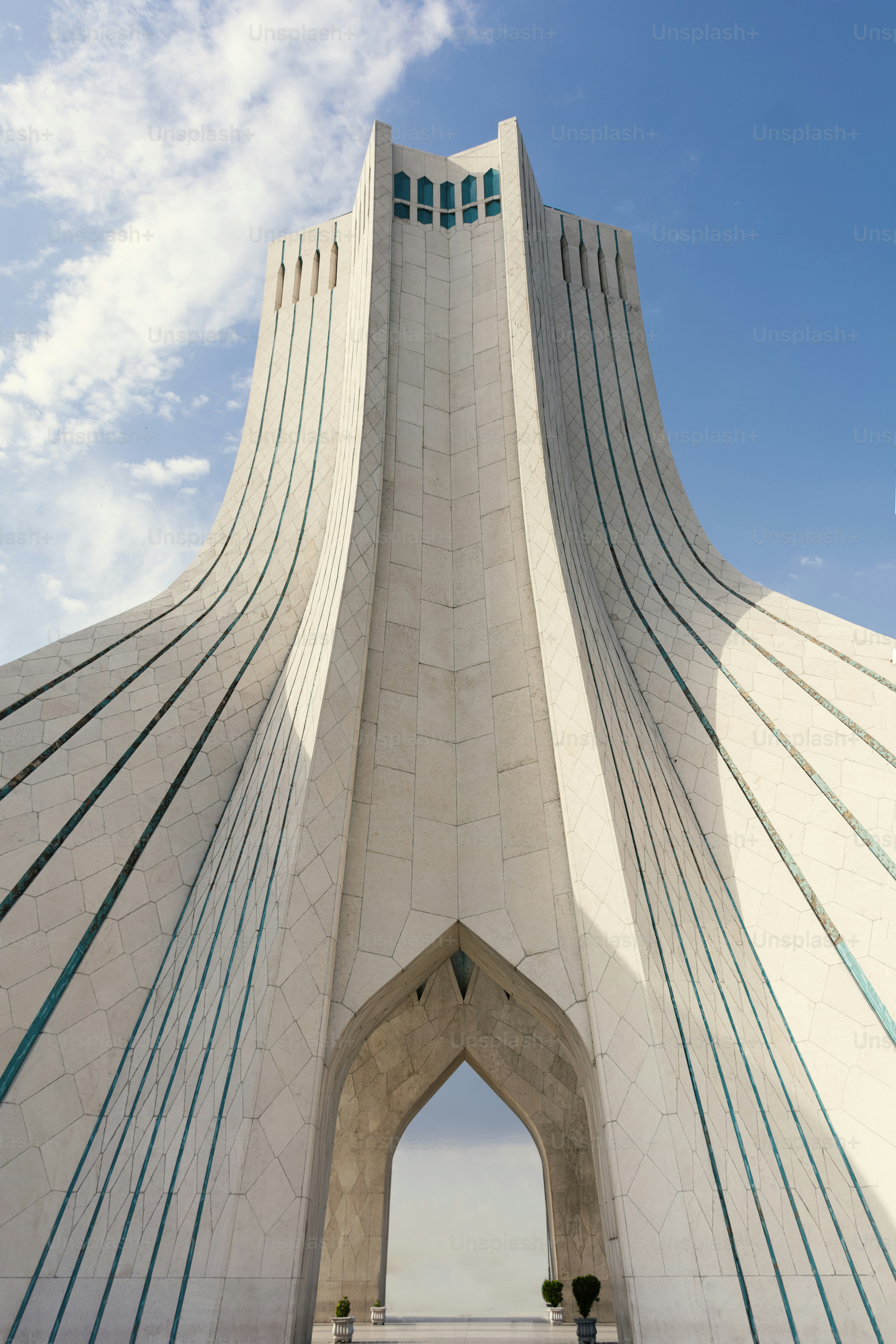 a tall white building with a large arched entrance