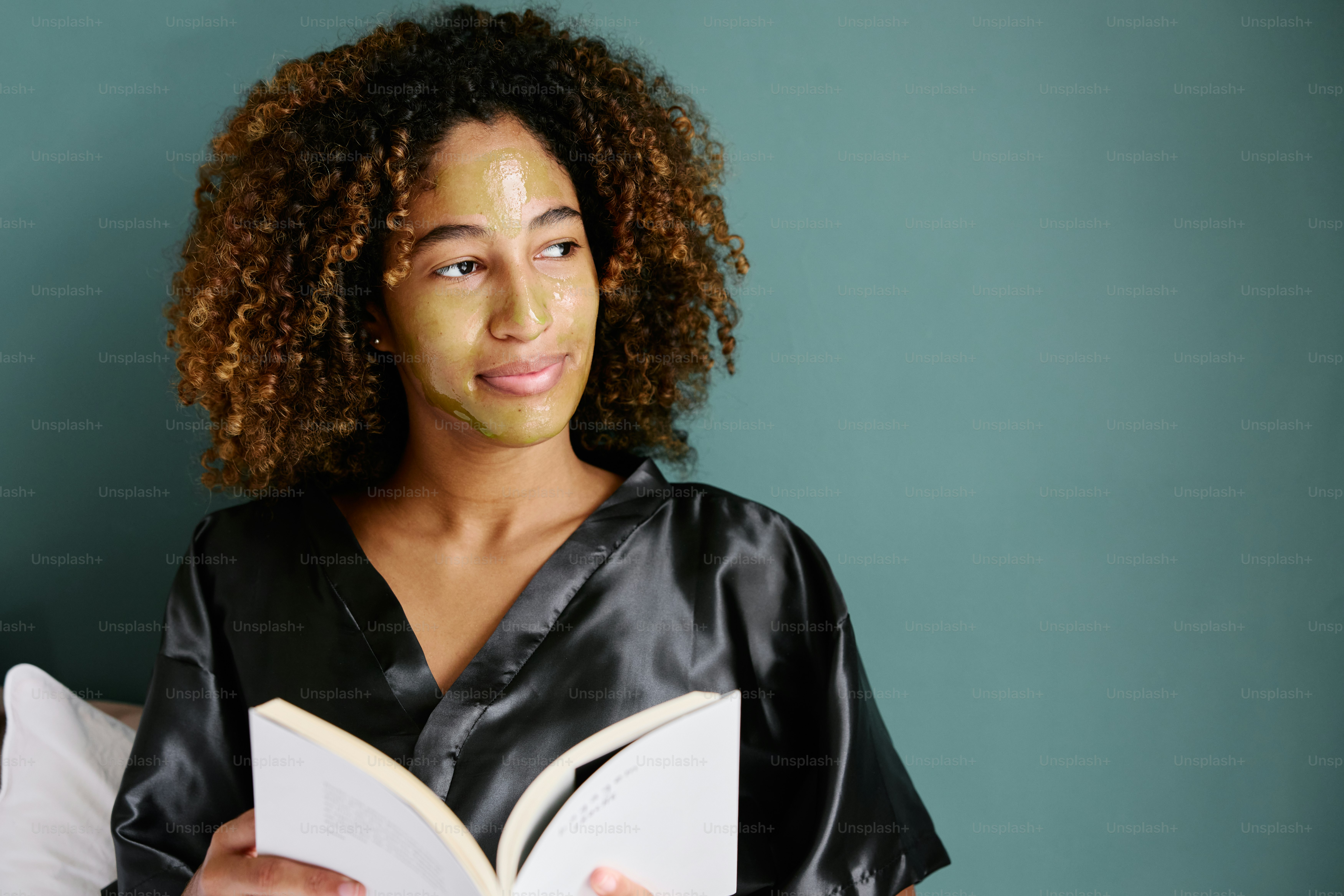 a woman with a face mask holding a book