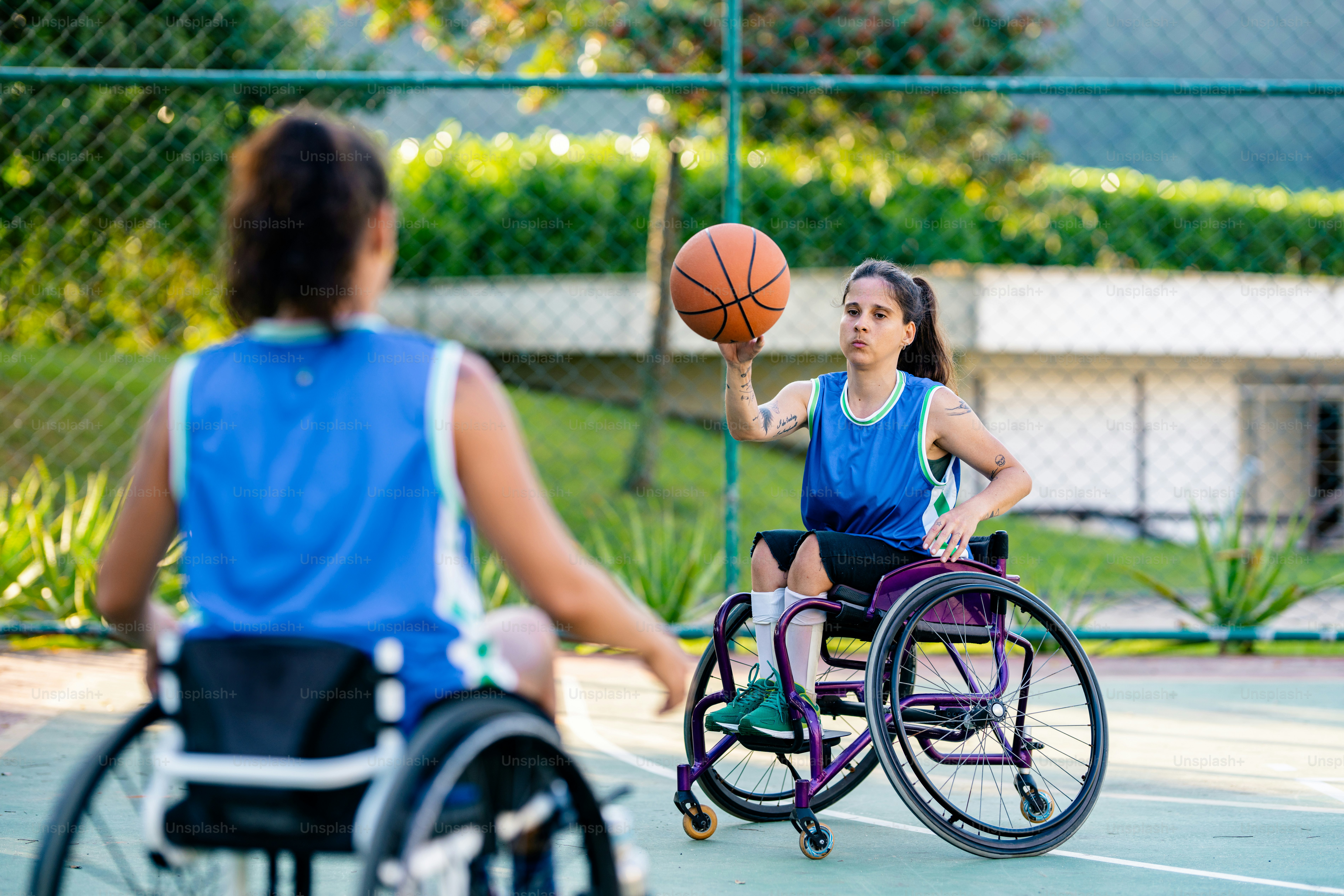 A woman in a wheel chair holding a basketball photo – Basketball Image ...