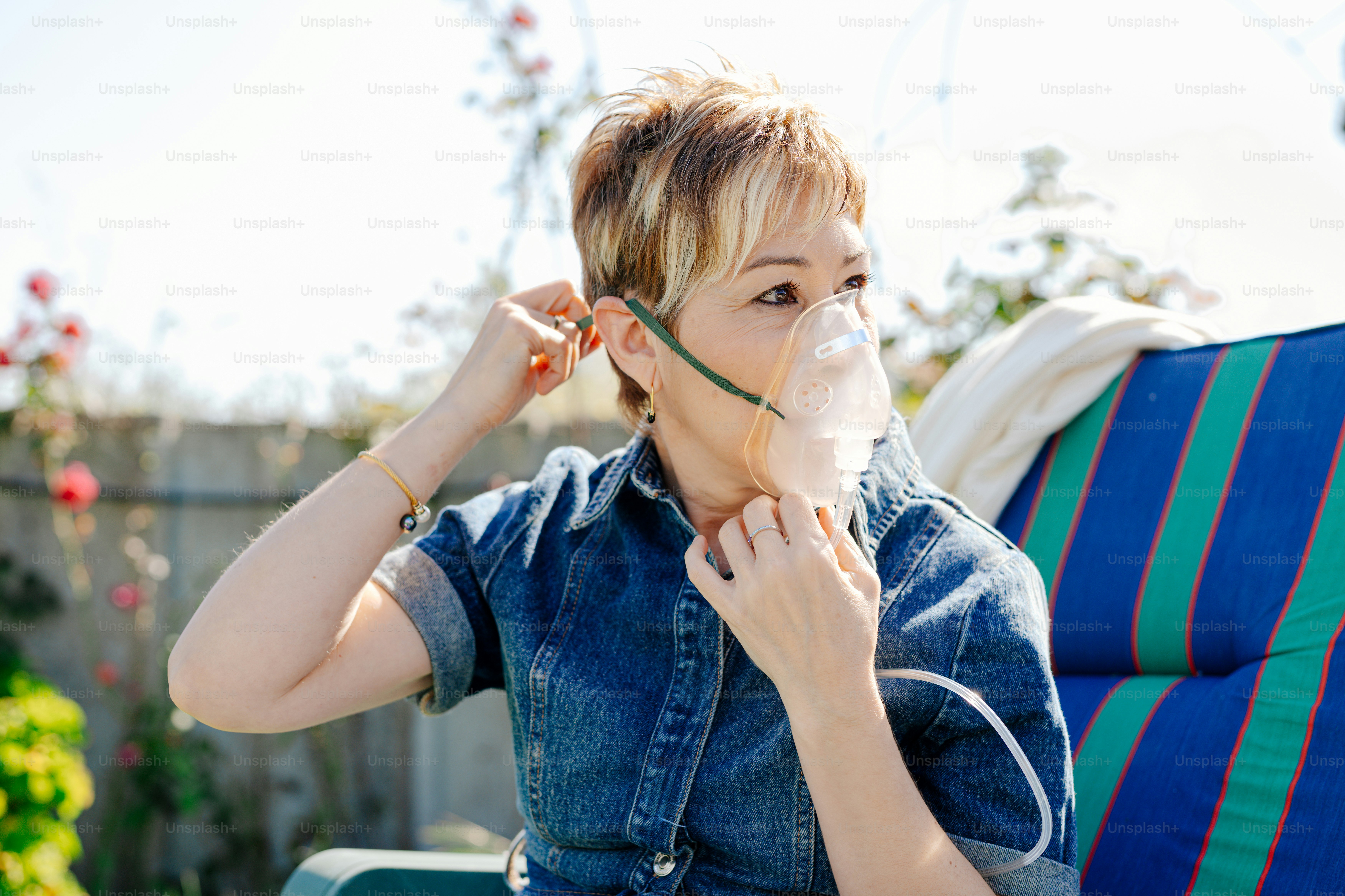 a woman sitting on a chair with a piece of plastic in her mouth