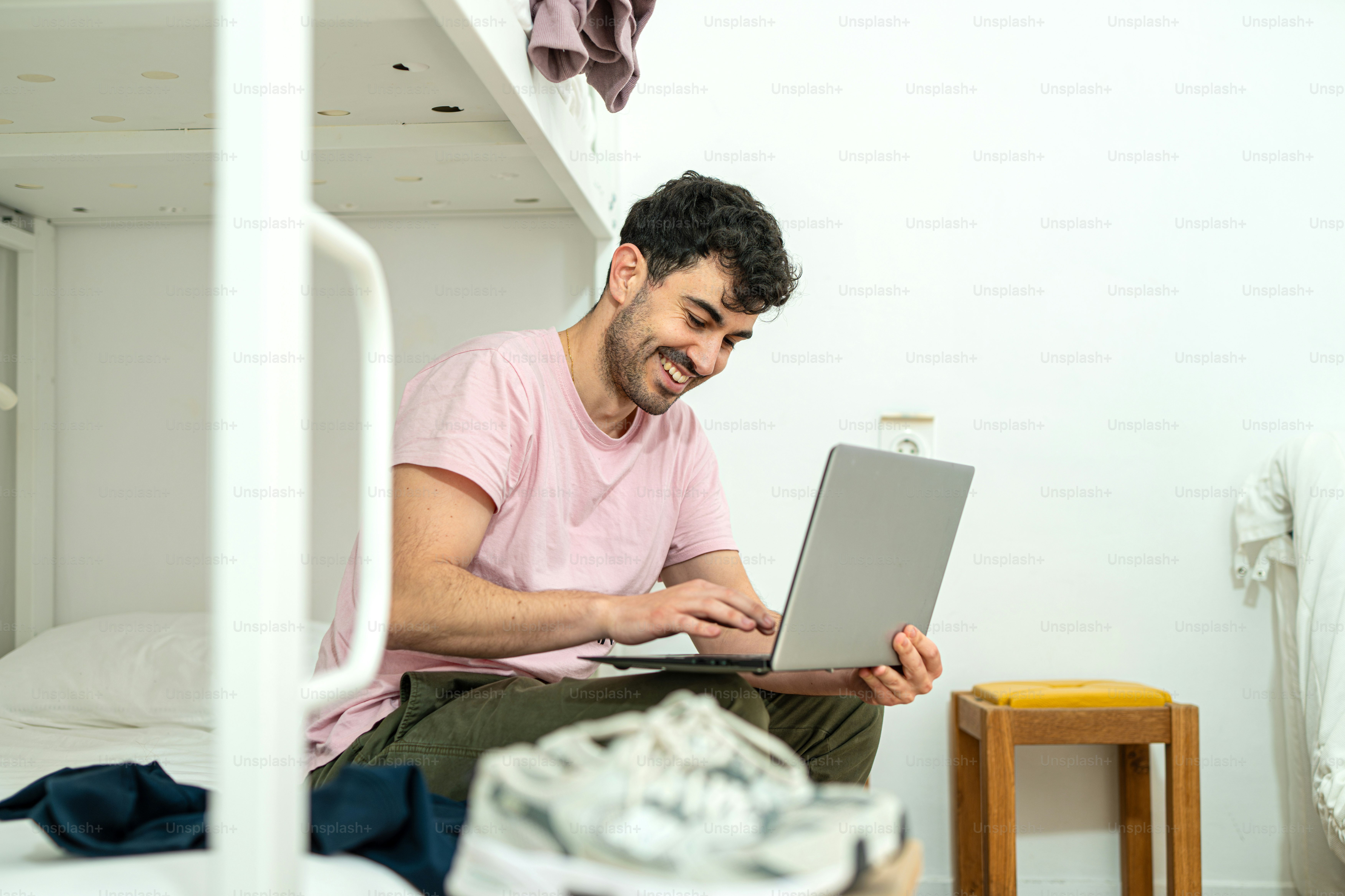 Traveler doing remote jobs for backpackers from a hostel workspace