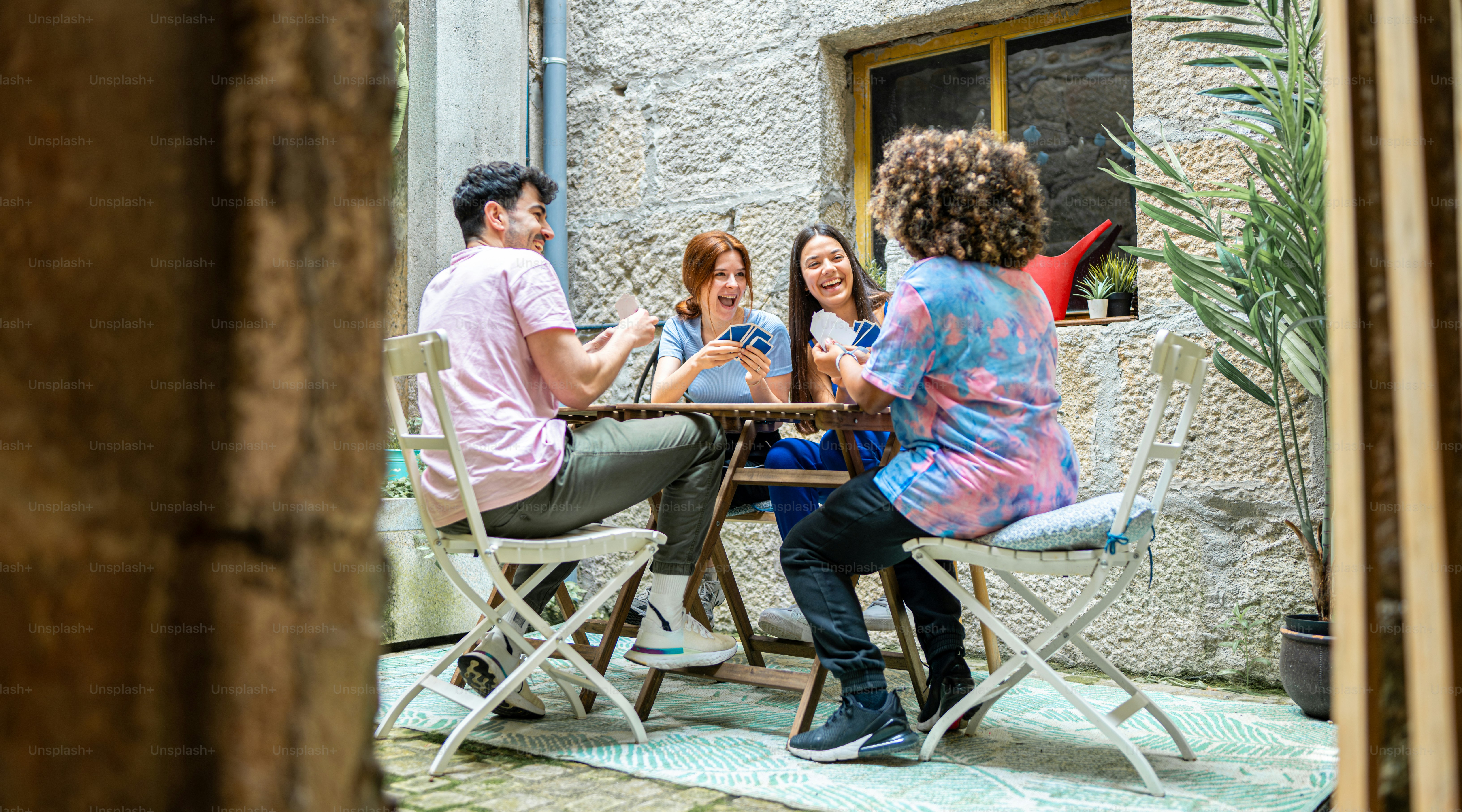a group of people sitting around a wooden table