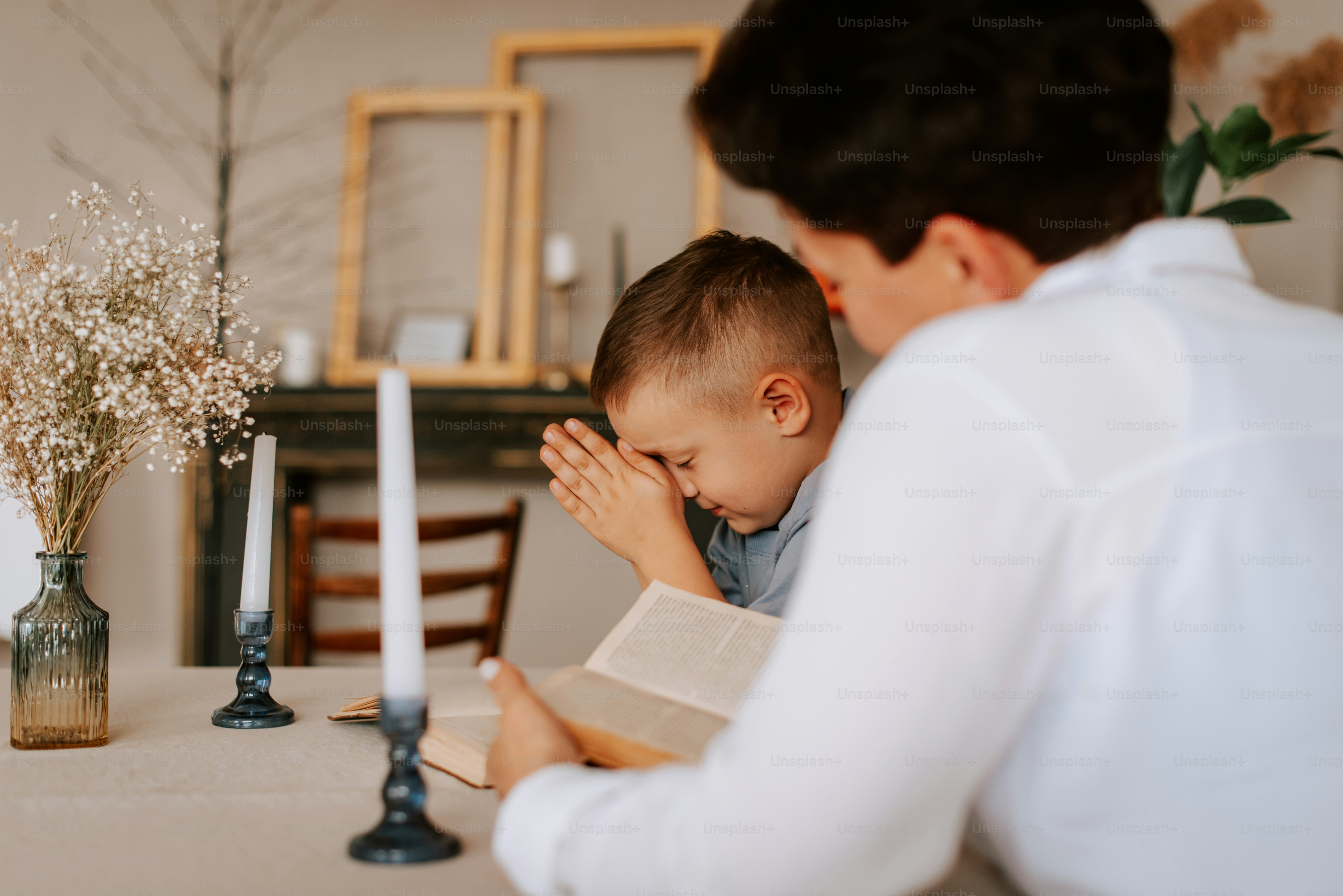 a man sitting at a table with a small child
