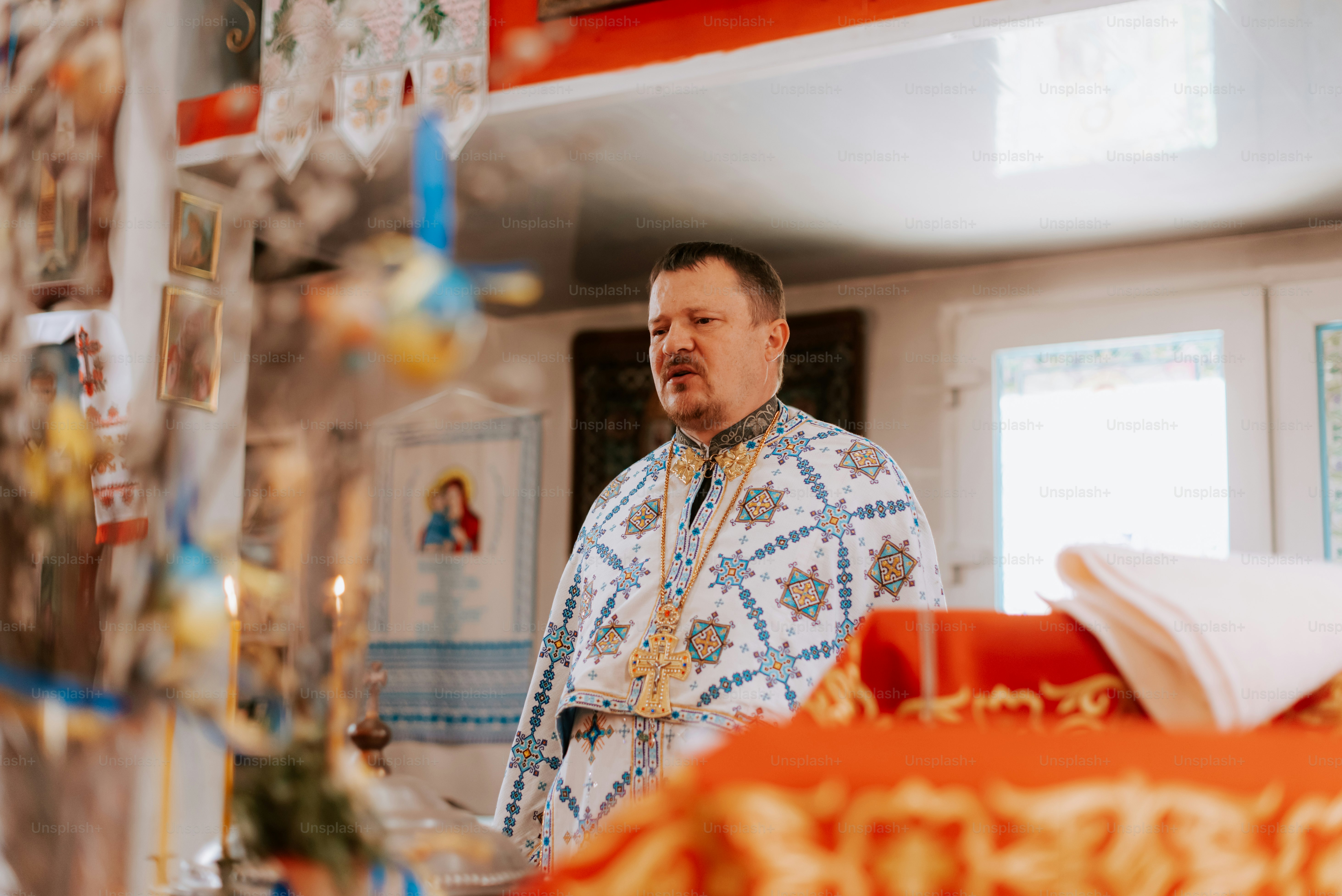 a man standing in a kitchen next to a table