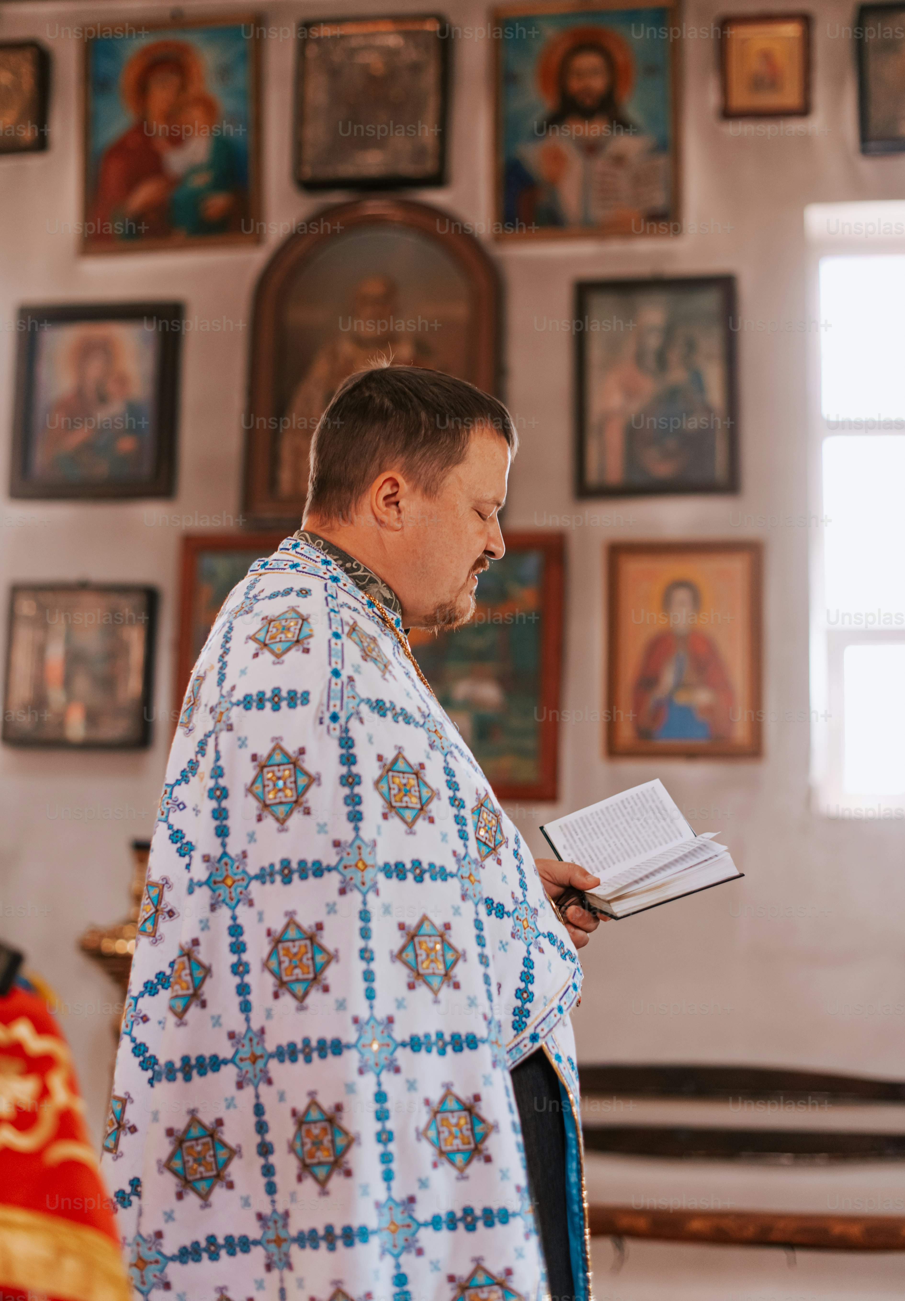 a priest reading a book in a church