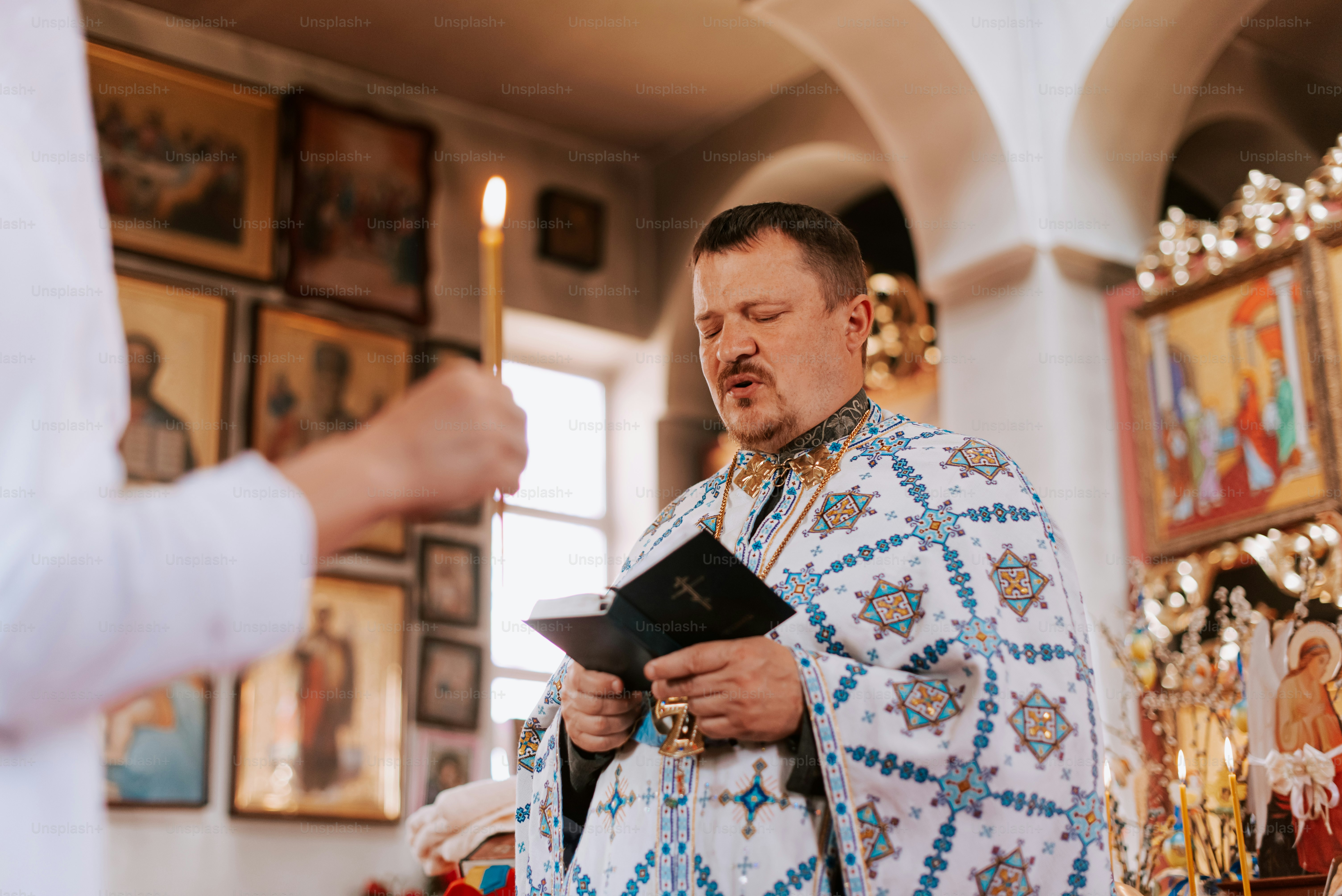 a man in a priest's outfit holding a bible