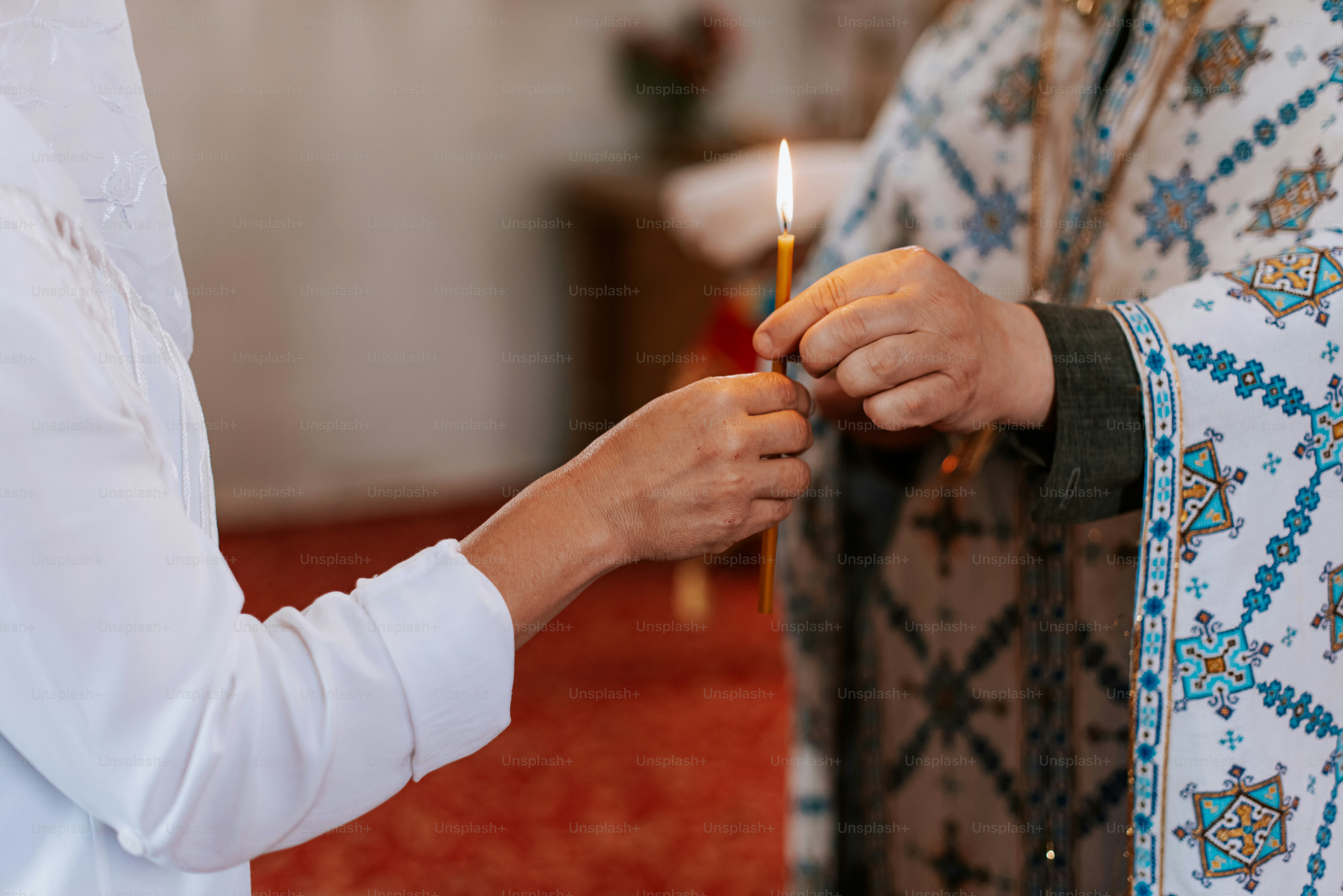 a person lighting a candle in a church