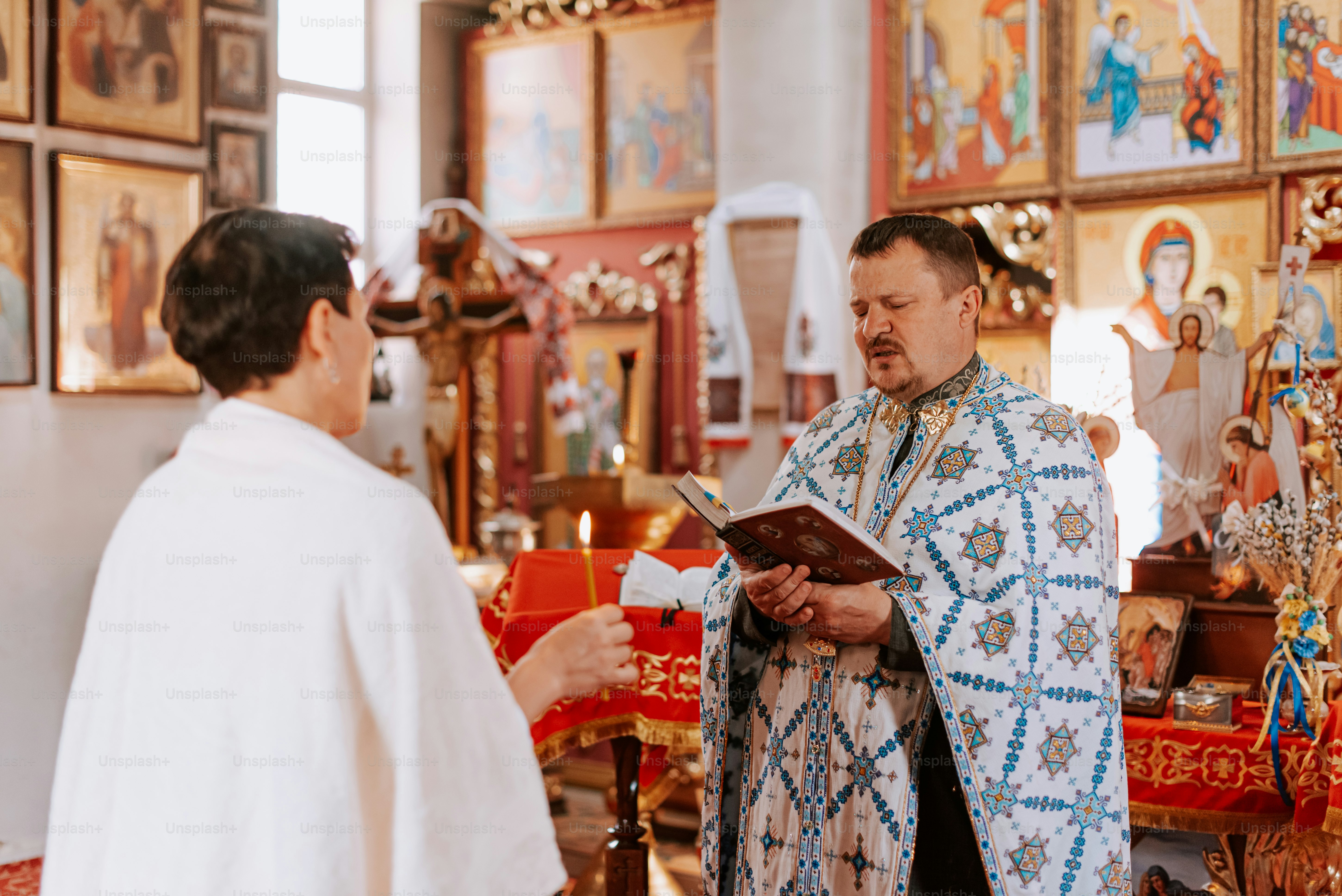 a priest is talking to a man in a church
