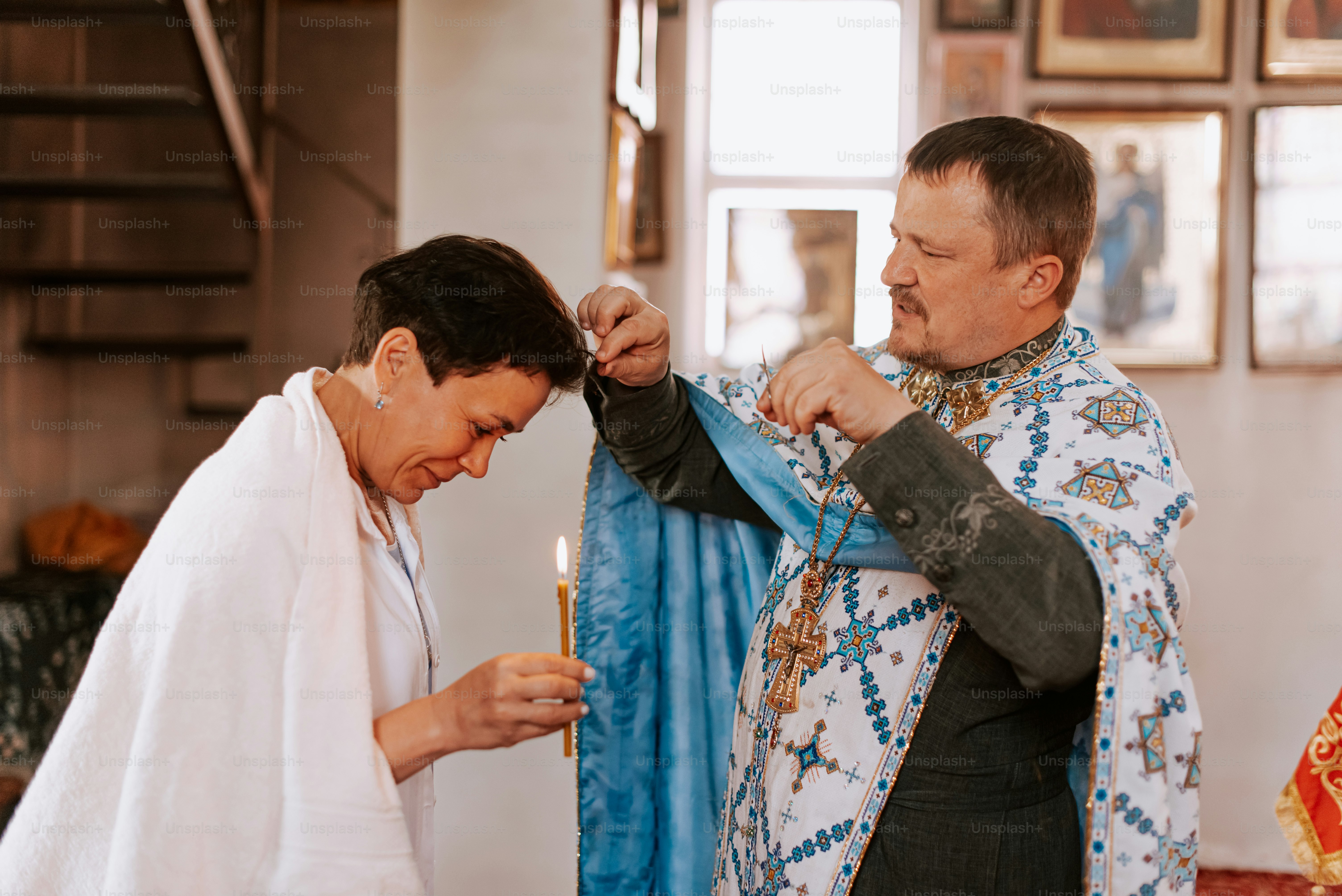 a man is lighting a candle next to a woman