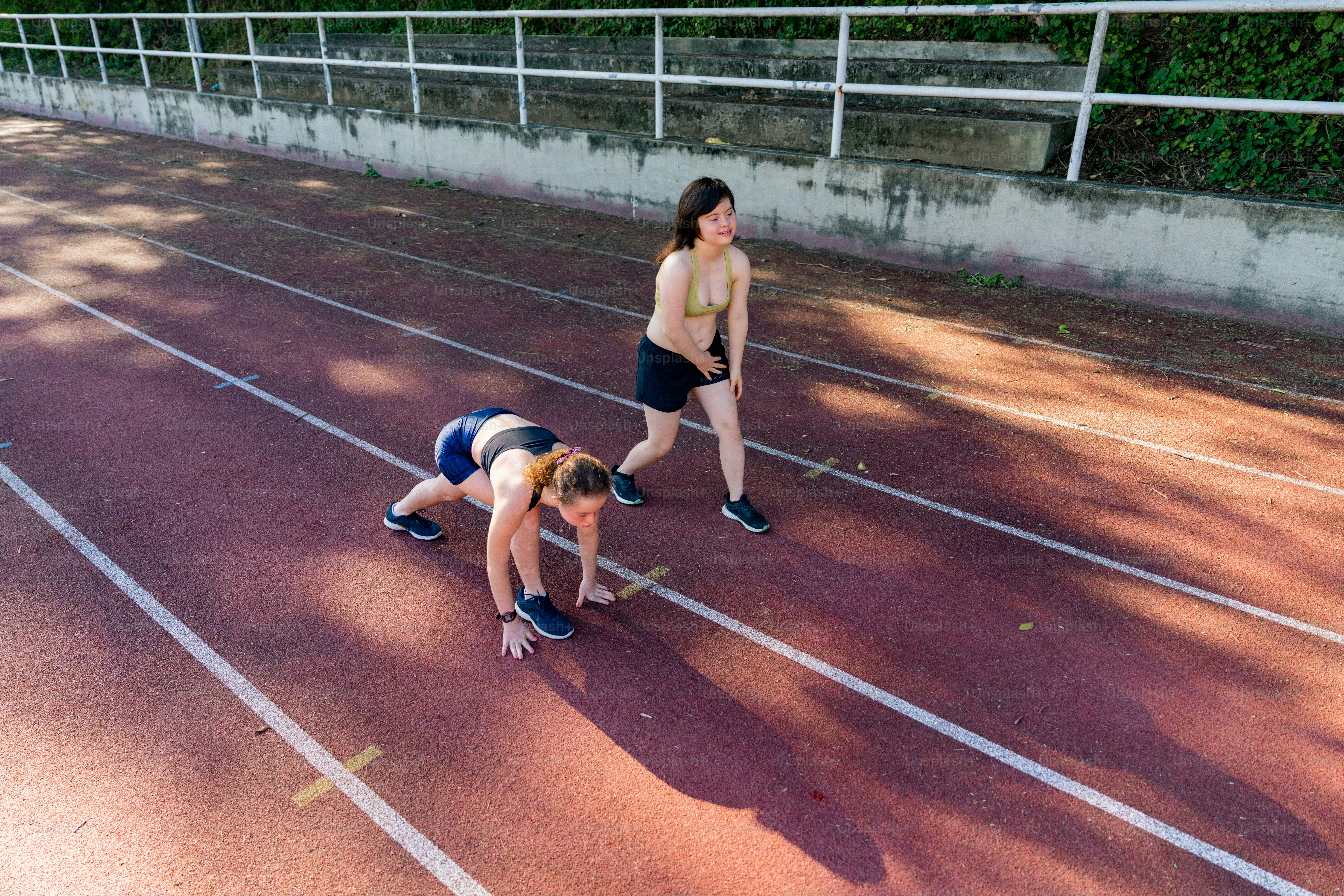 A couple of people that are standing on a track photo – Sport Image on ...