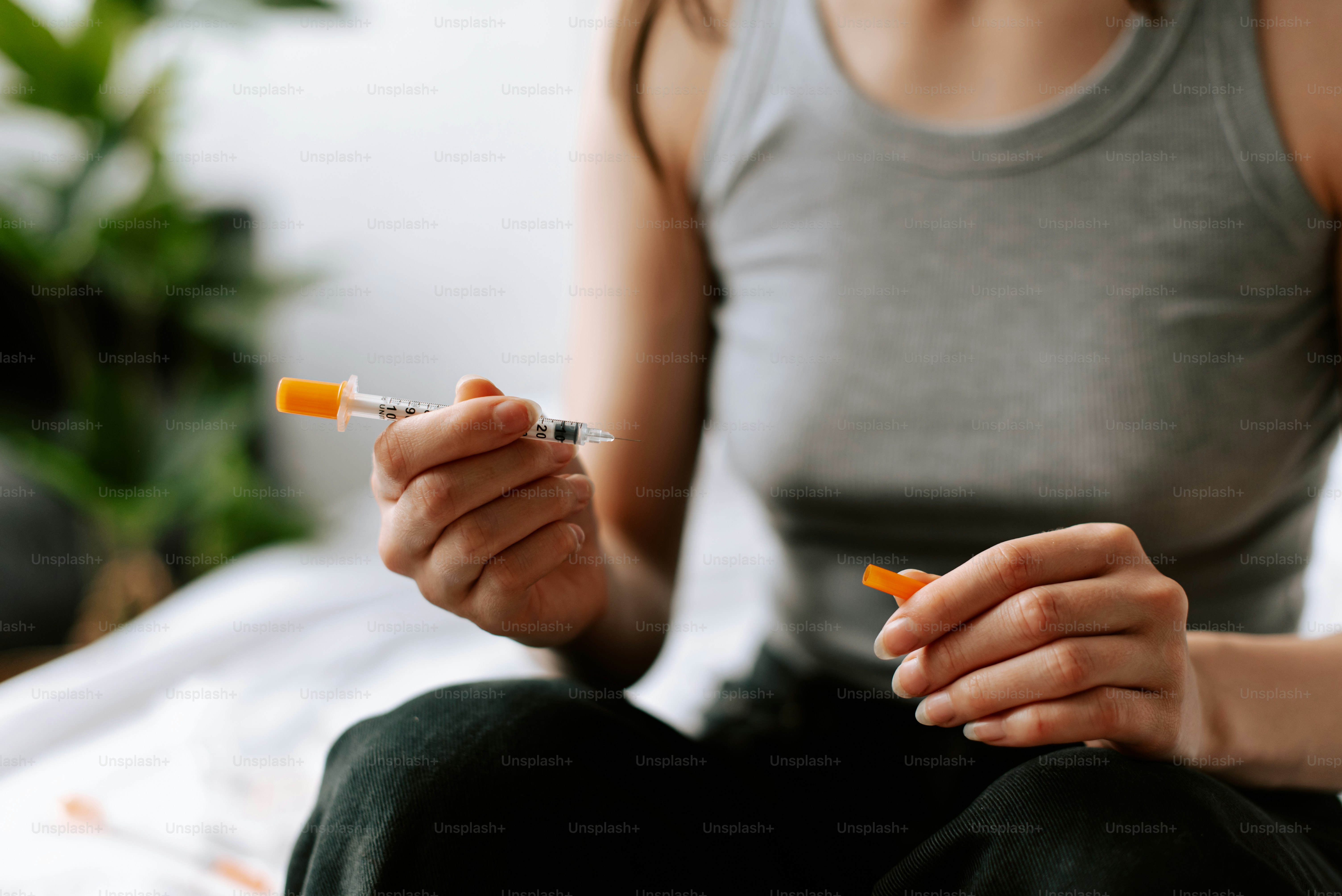 a woman sitting on a bed holding a cigarette