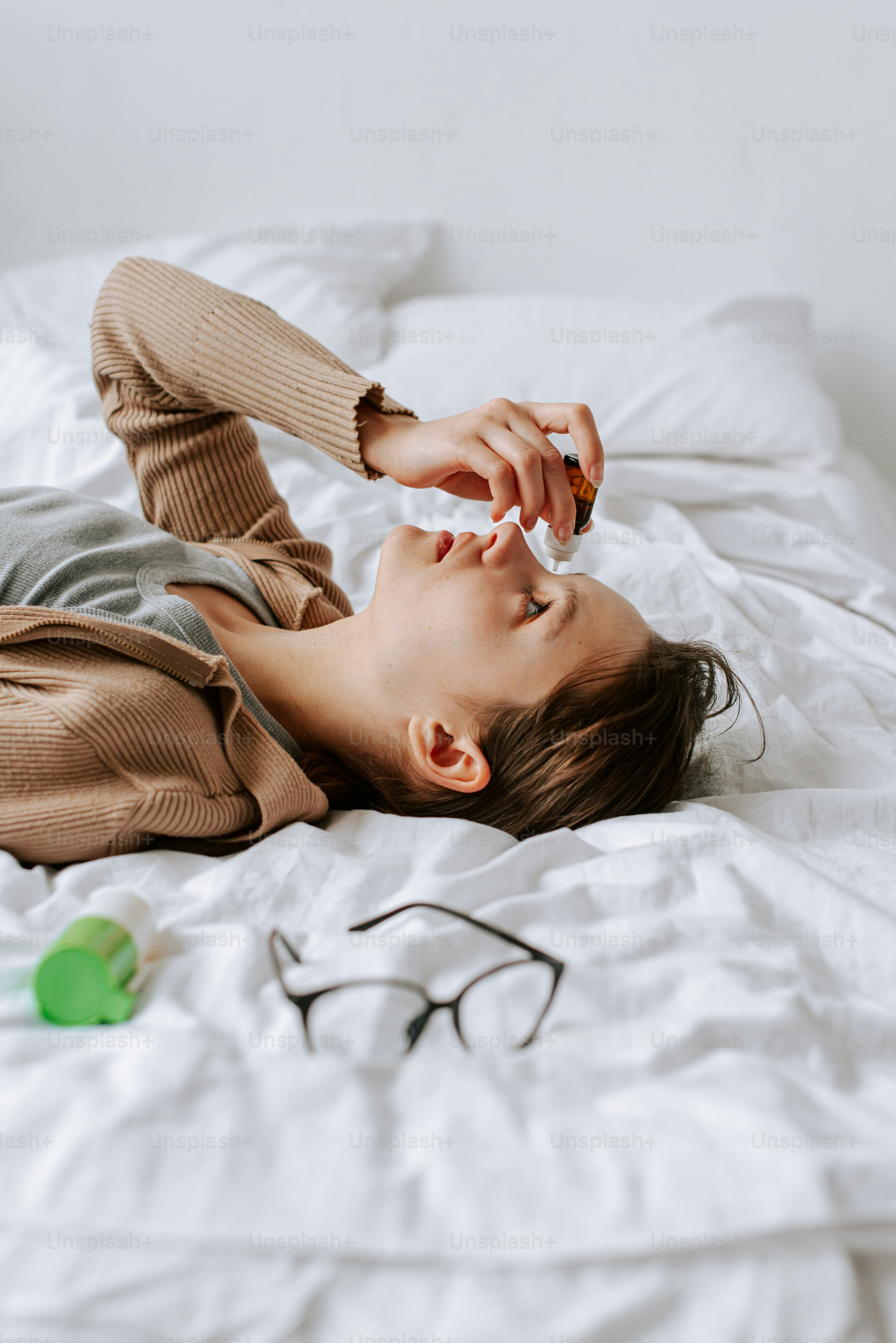 a woman laying on top of a white bed