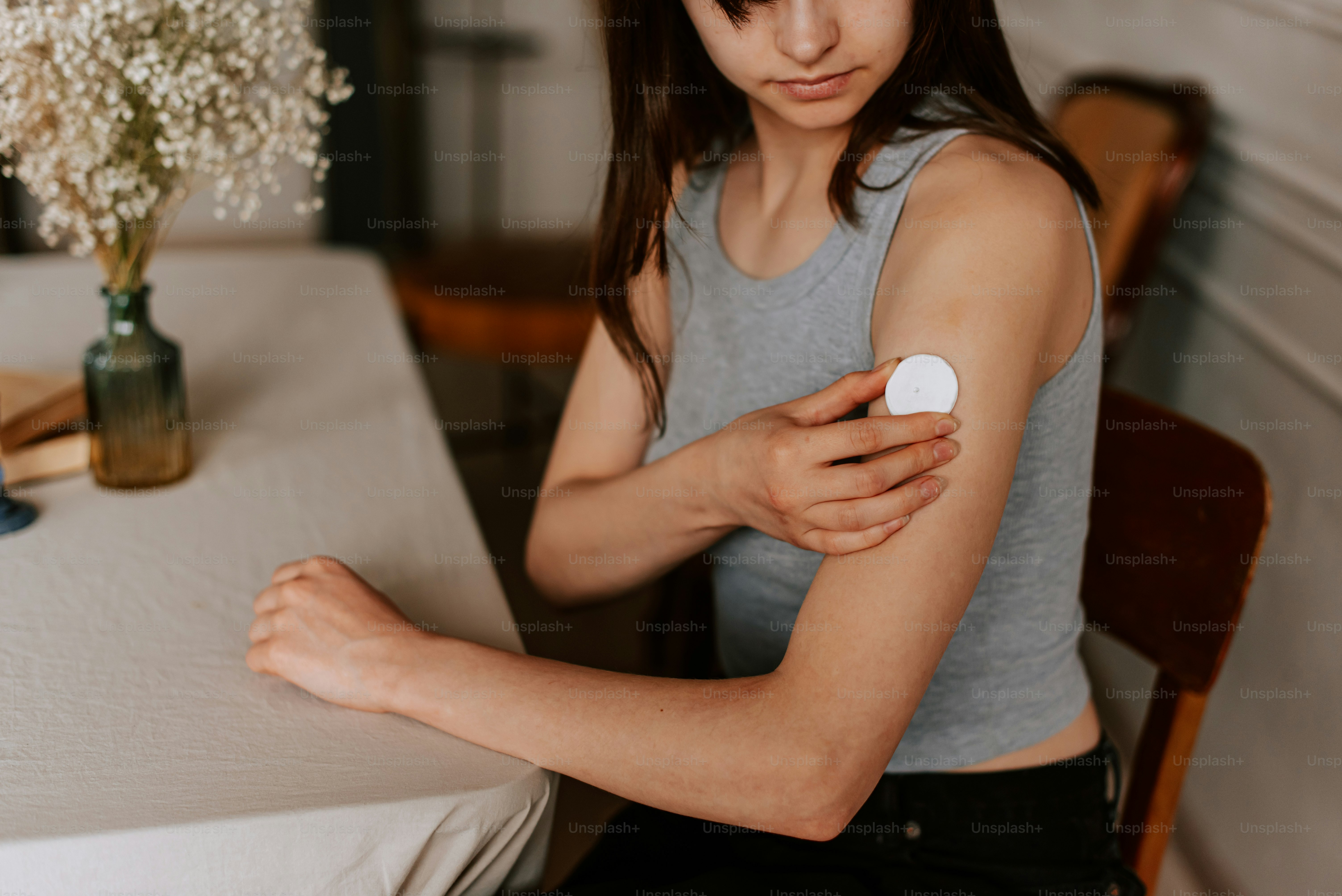 a woman sitting at a table with her arm wrapped around a piece of paper
