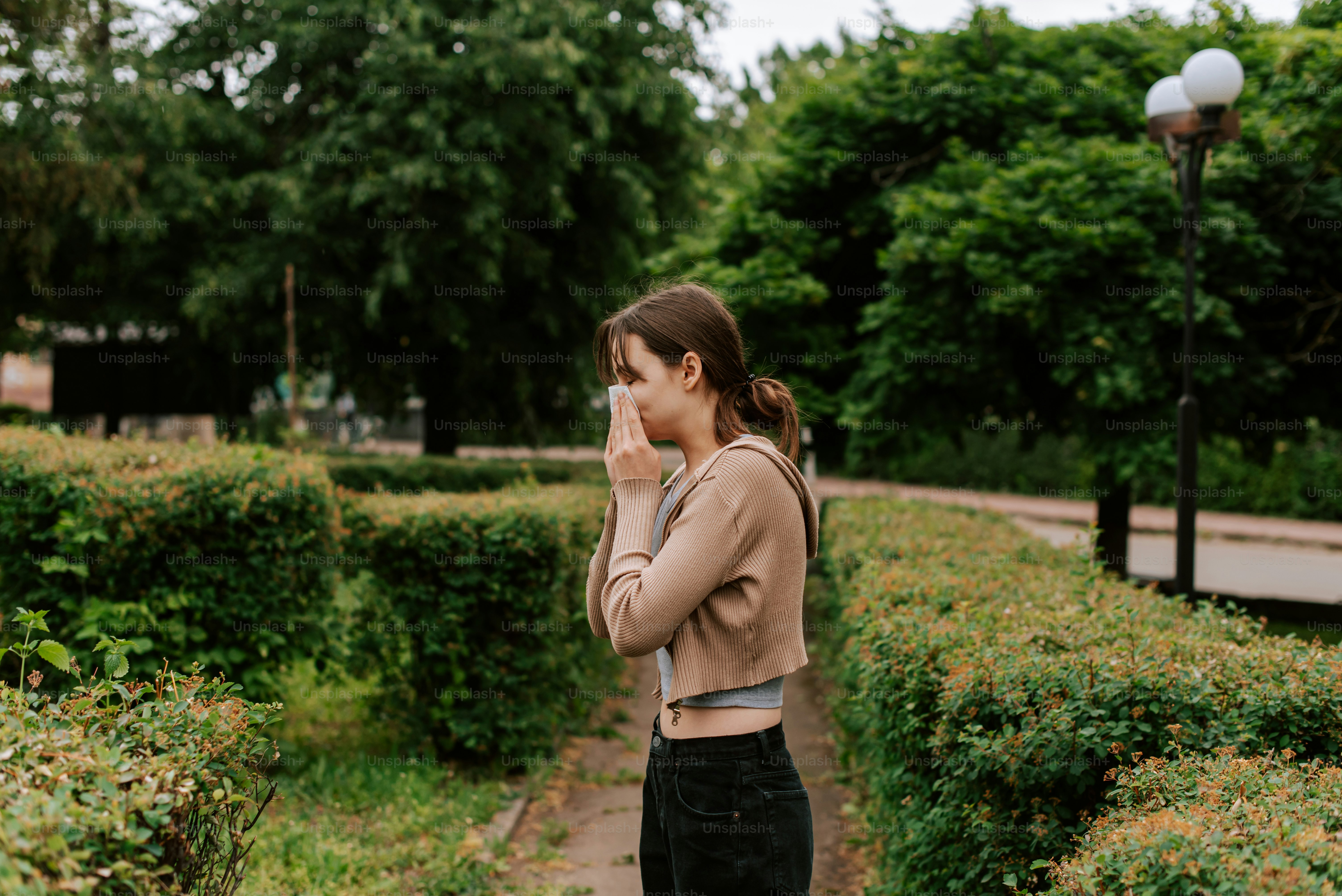 a woman standing in front of a lush green park