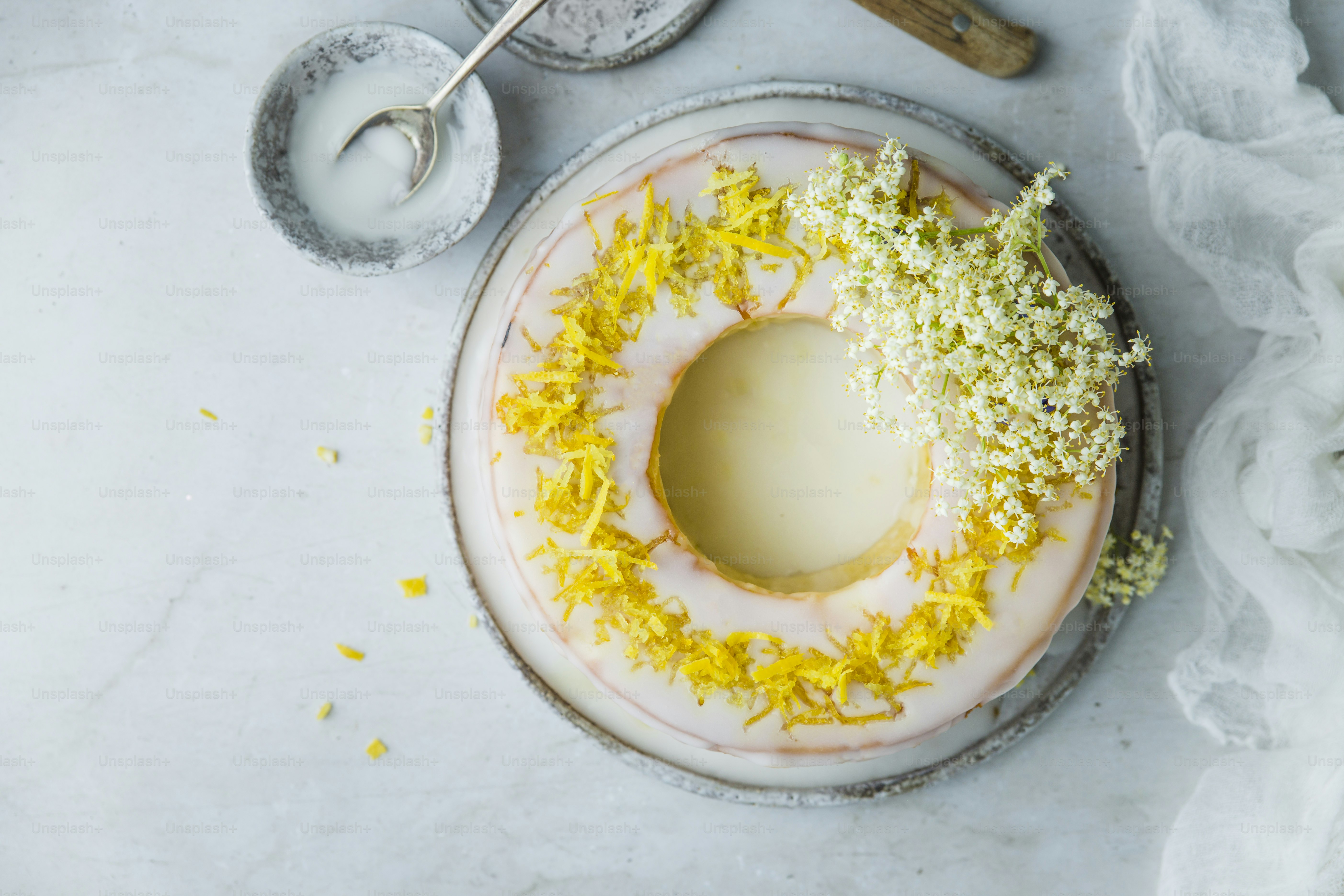 a cake with yellow and white frosting and sprinkles
