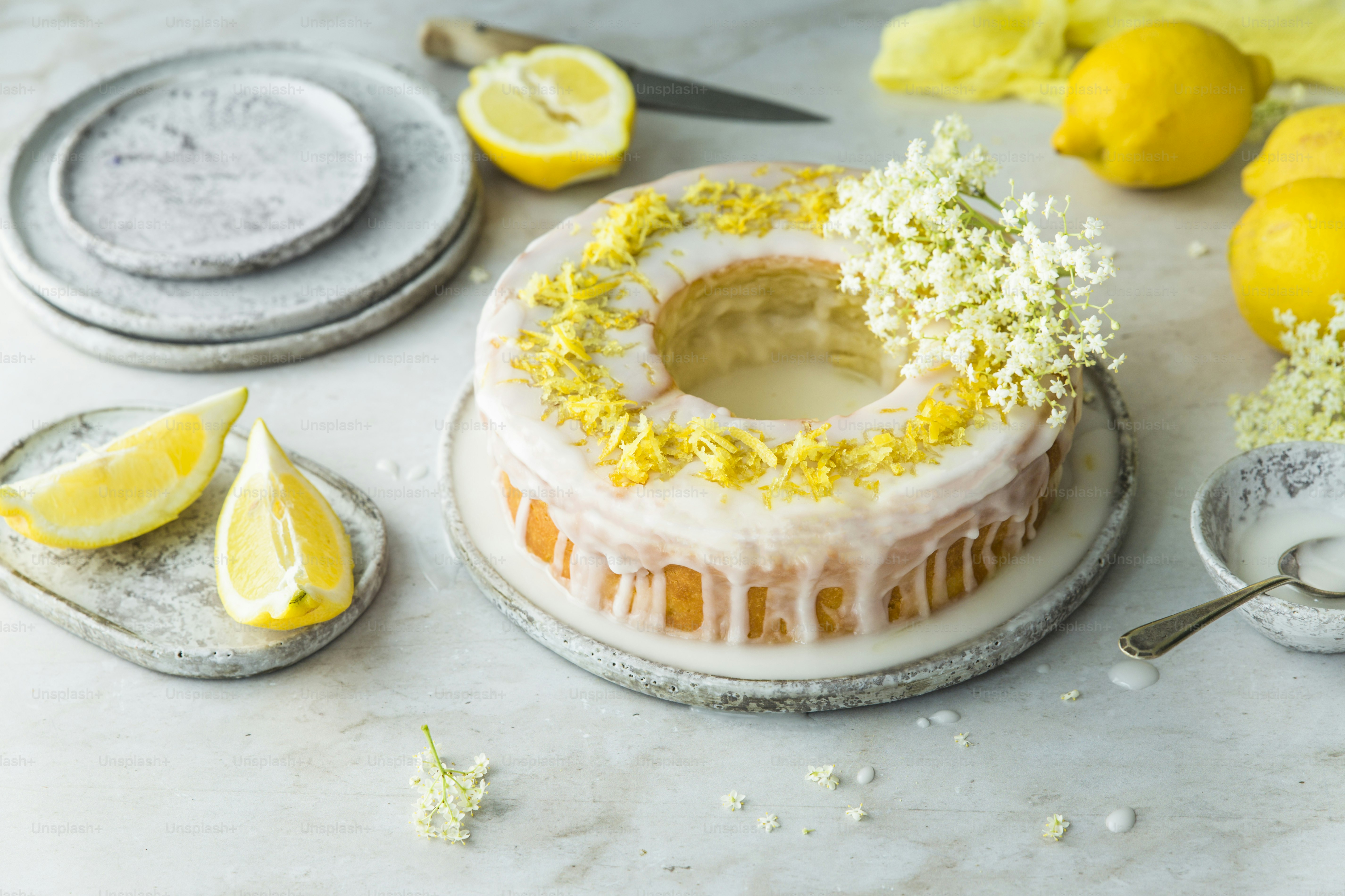 a cake with lemons and flowers on it