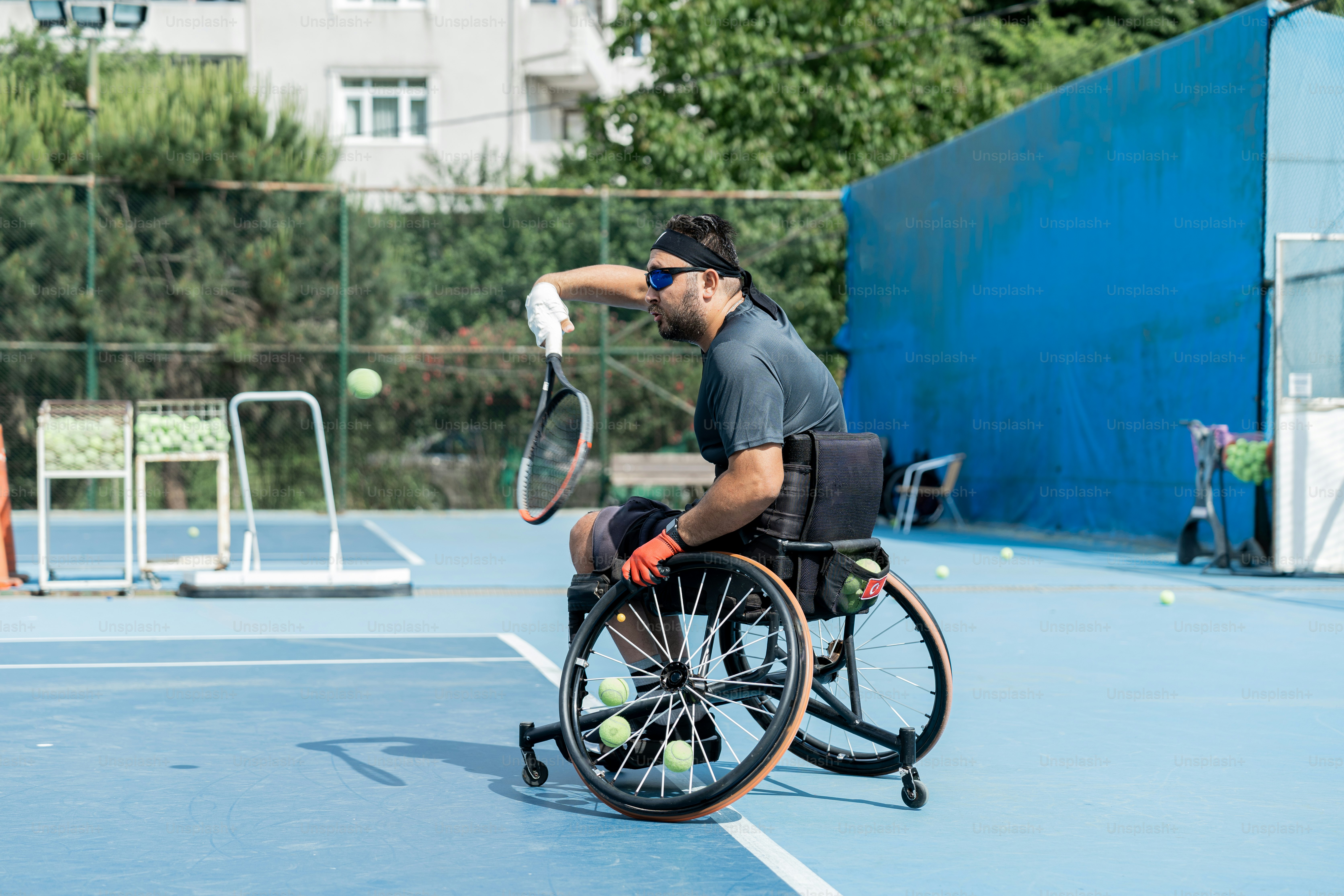 un uomo su una sedia a rotelle che gioca a tennis su un campo