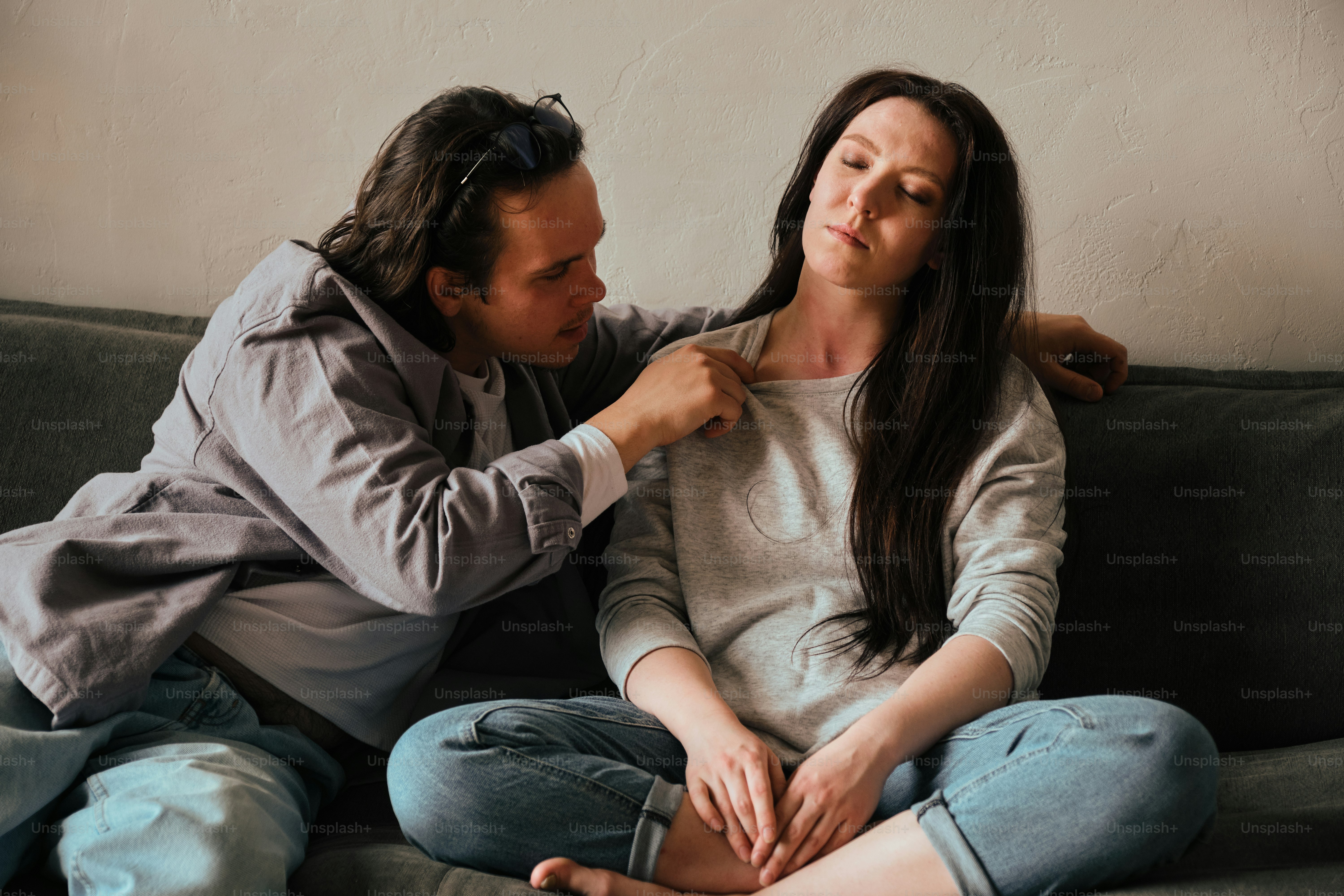 a man helping a woman fix her tie