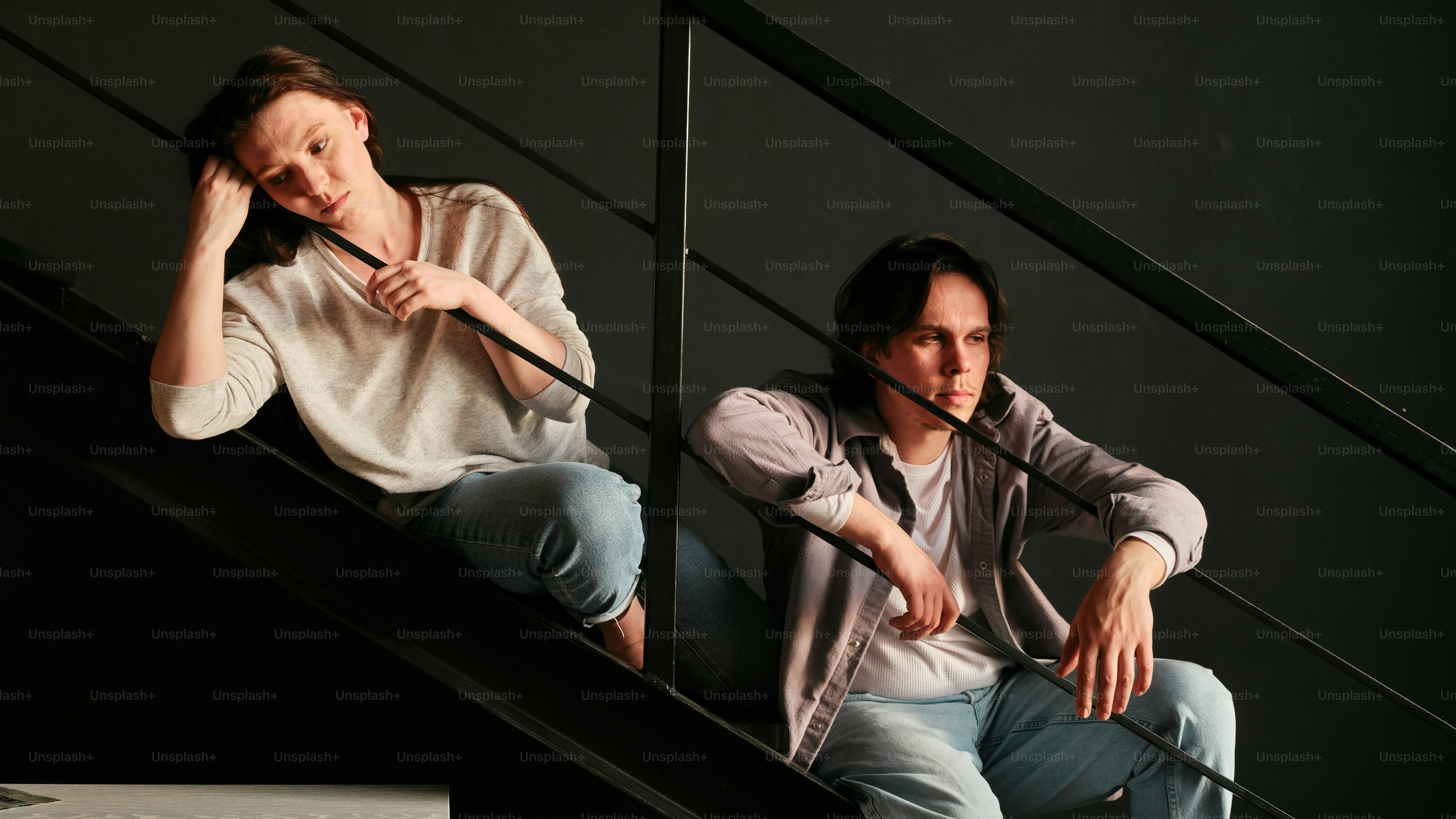 a couple of people that are sitting on some stairs