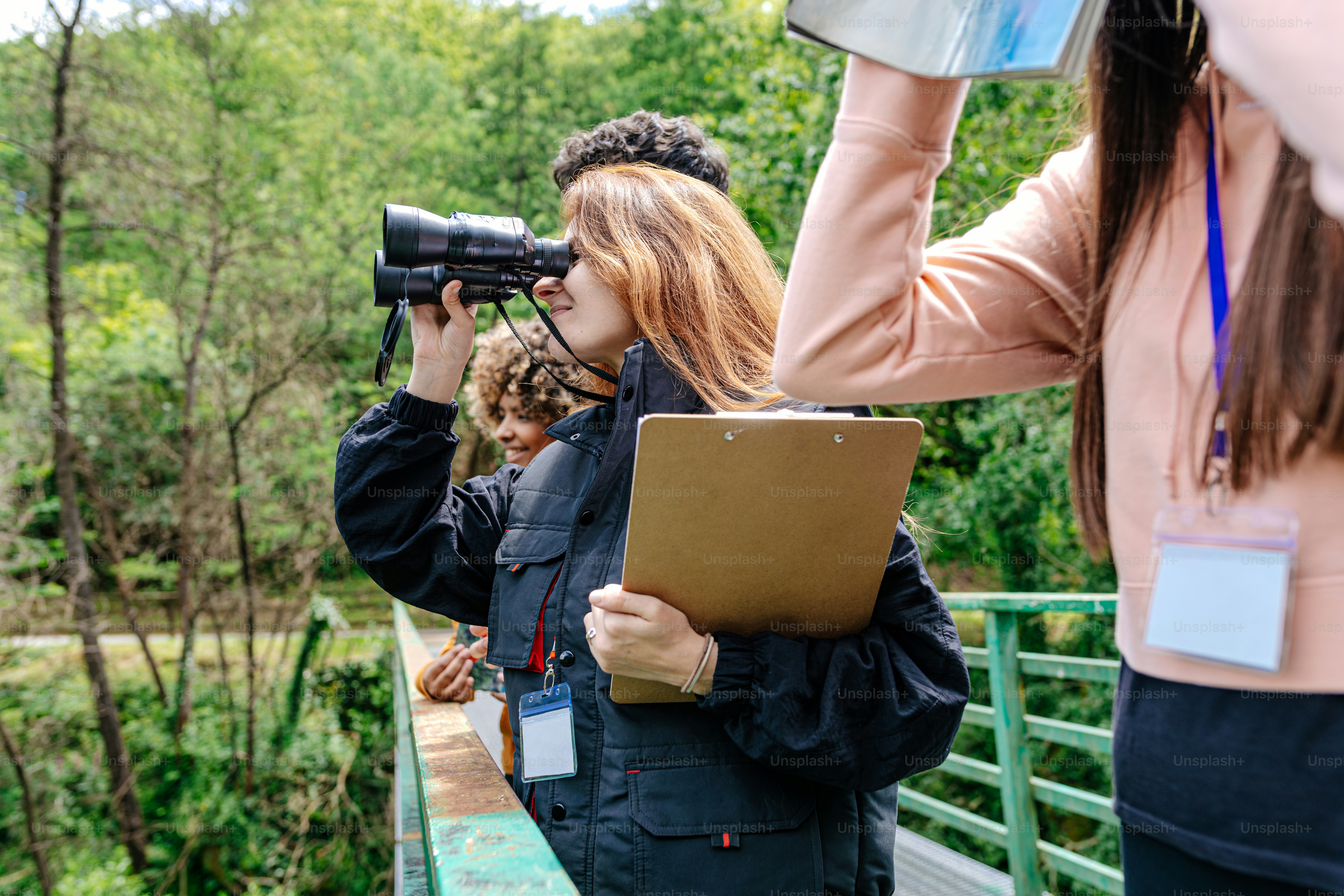 a group of people standing next to each other on a bridge