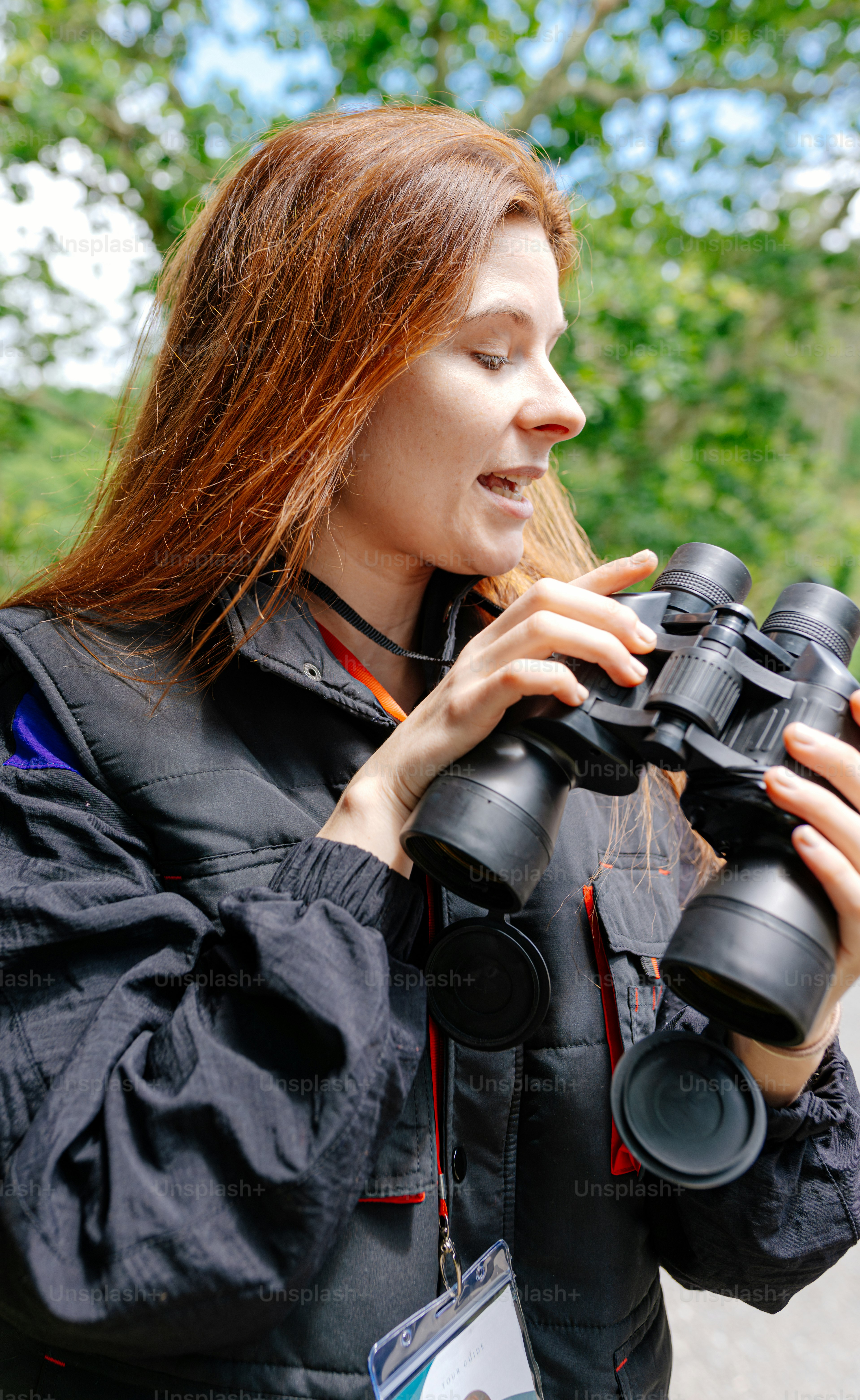 A woman looking through a pair of binoculars photo – Bird spotting ...