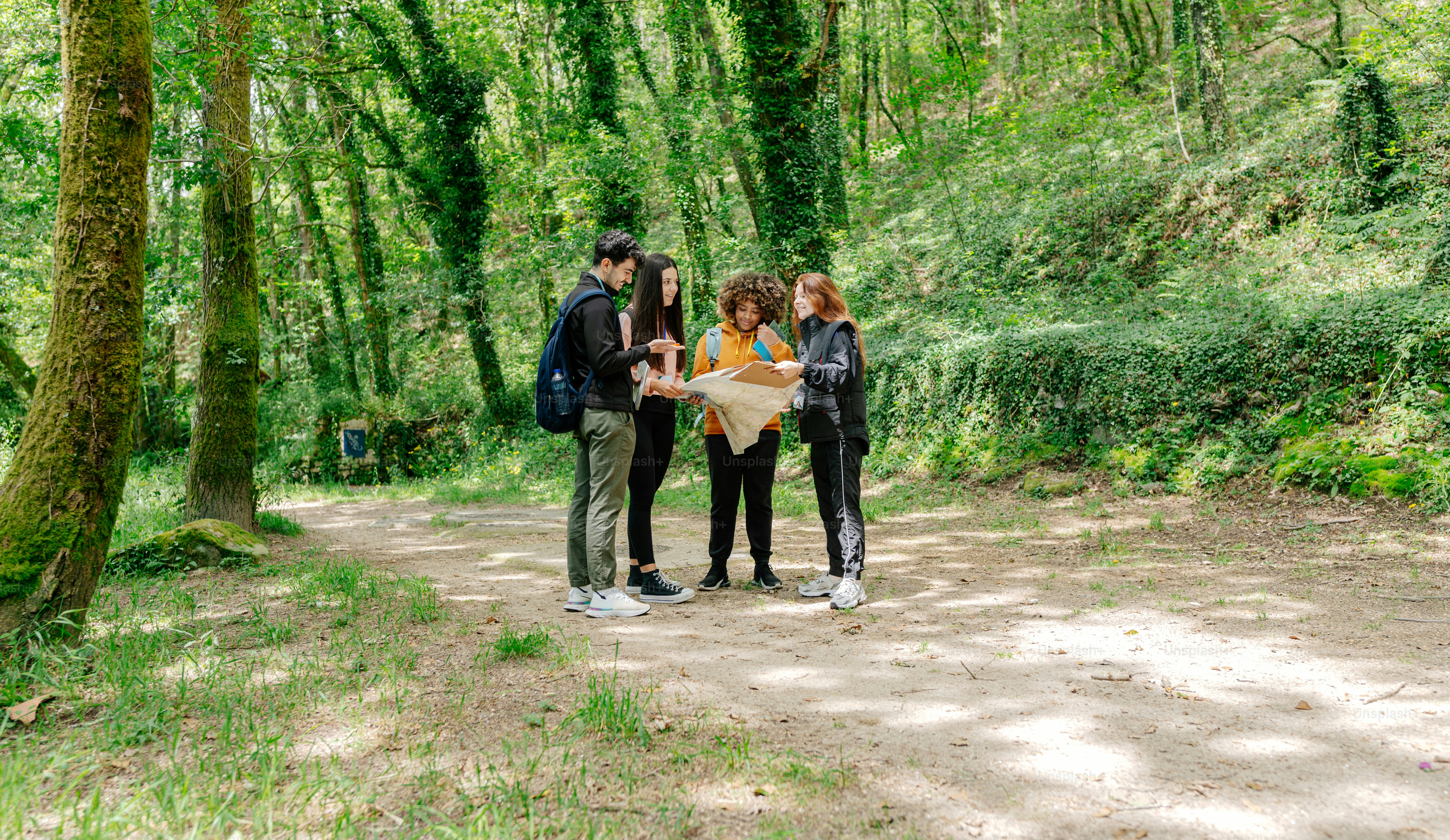 a group of people standing on a dirt road