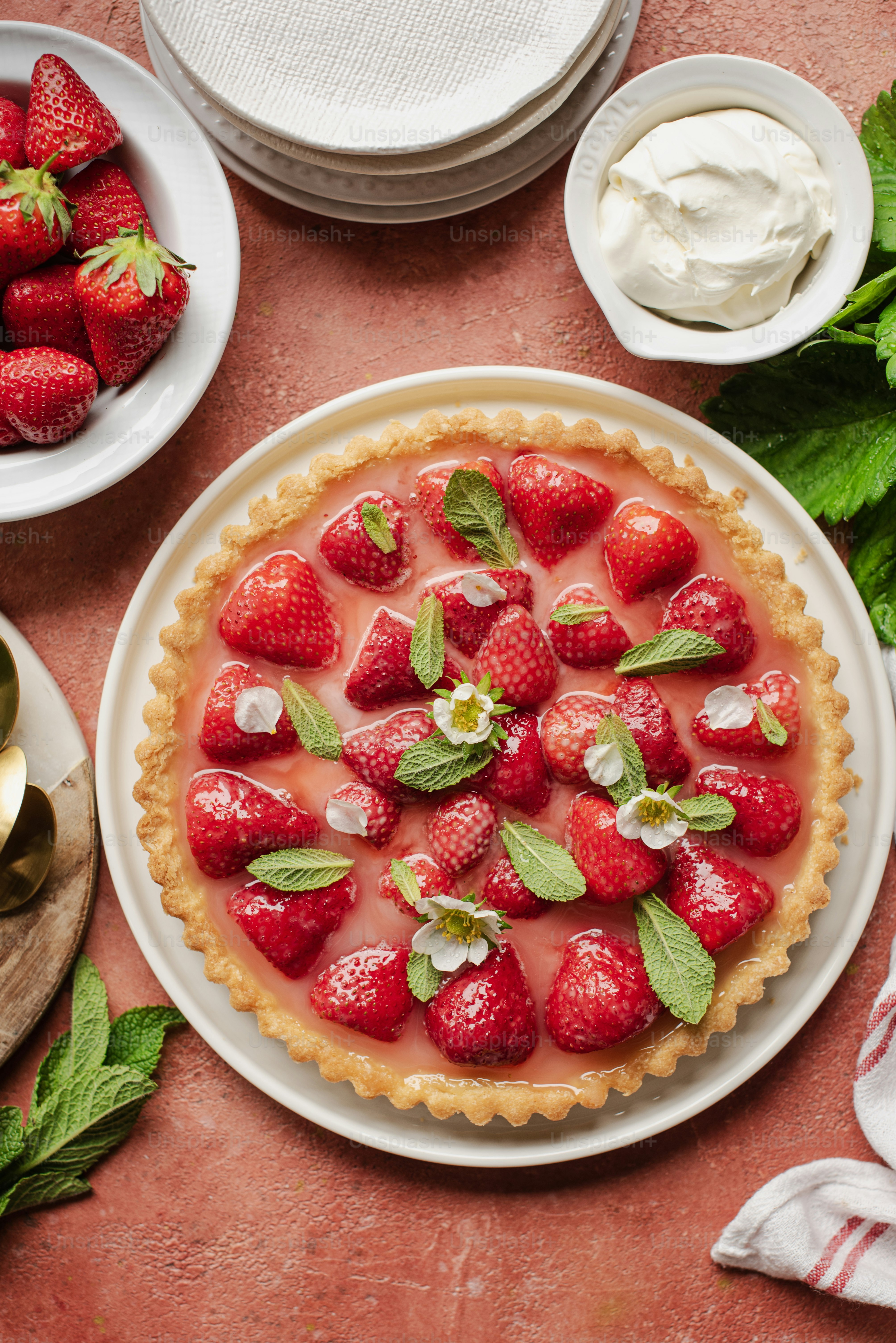 a pie with strawberries on top of it on a table