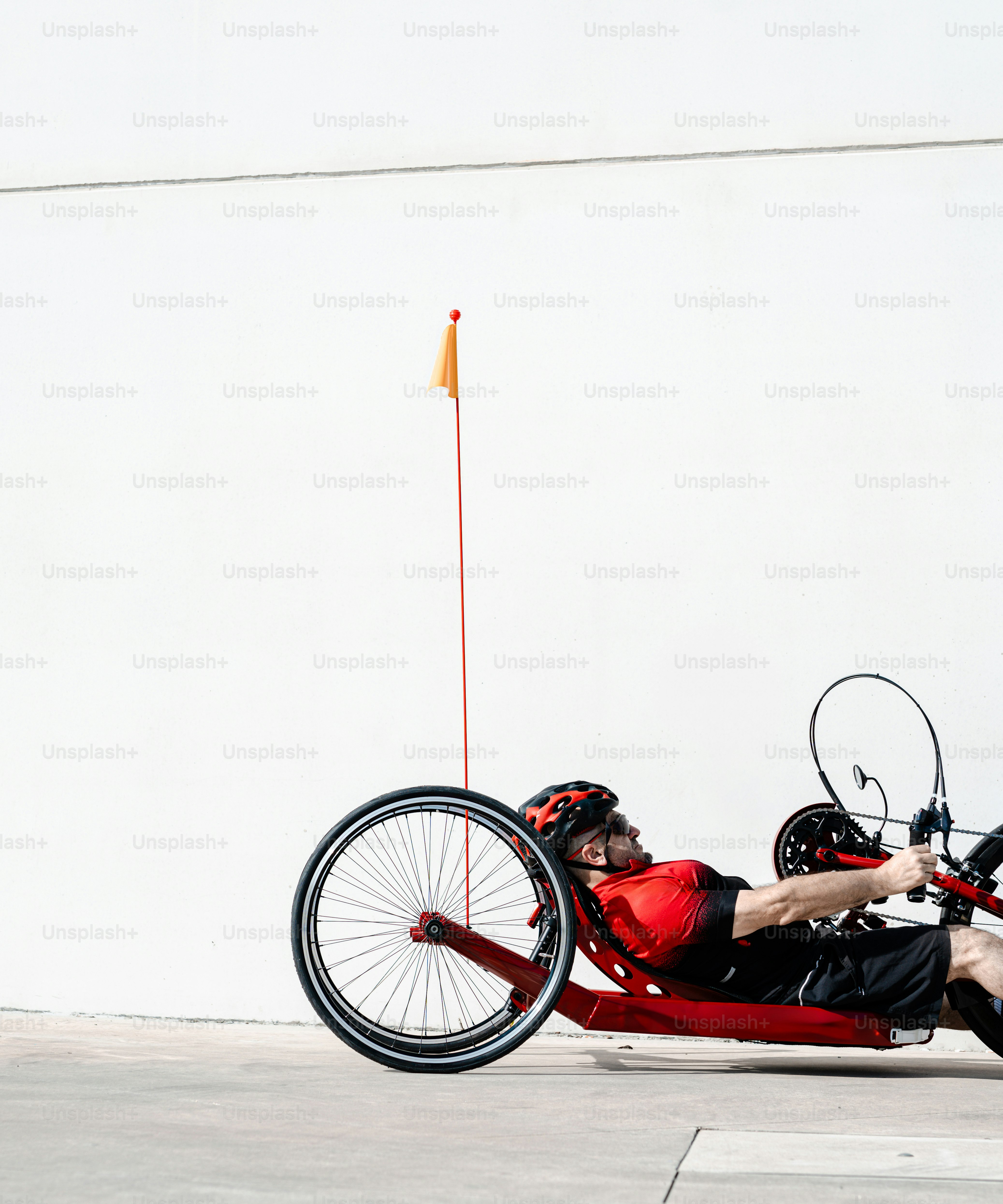 a man laying on the ground next to a bike