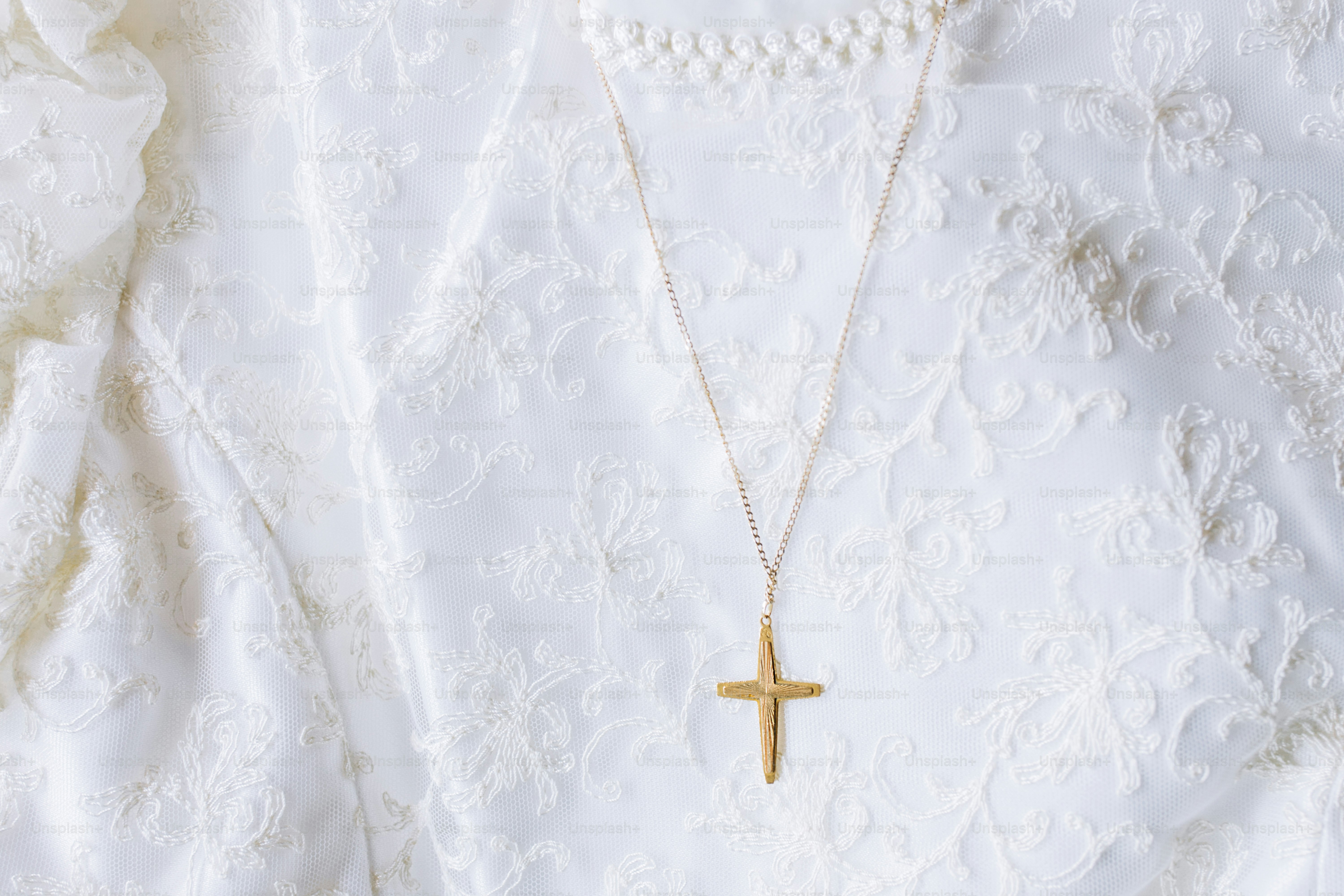 a necklace with a cross hanging from it