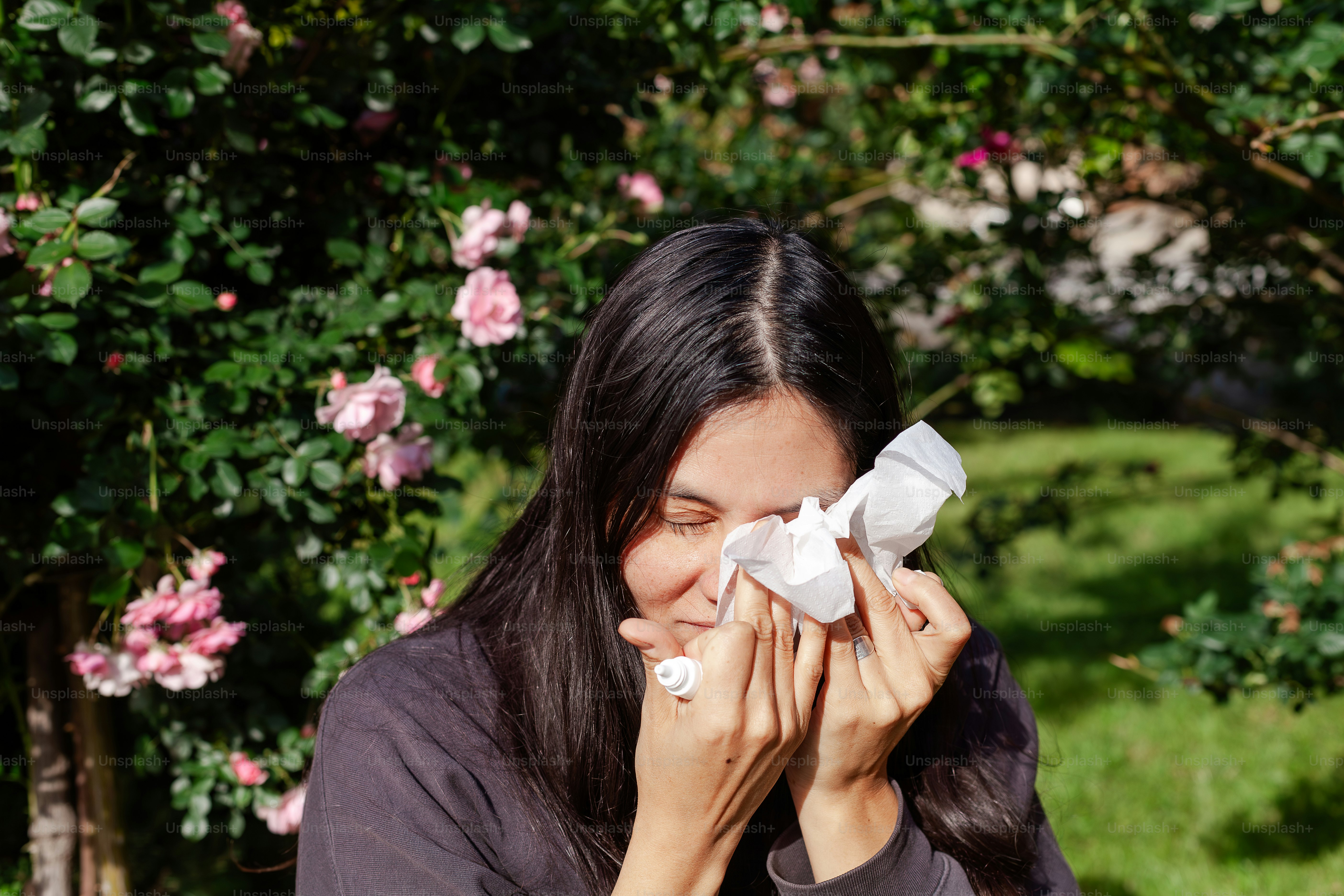 a woman holding a napkin over her face