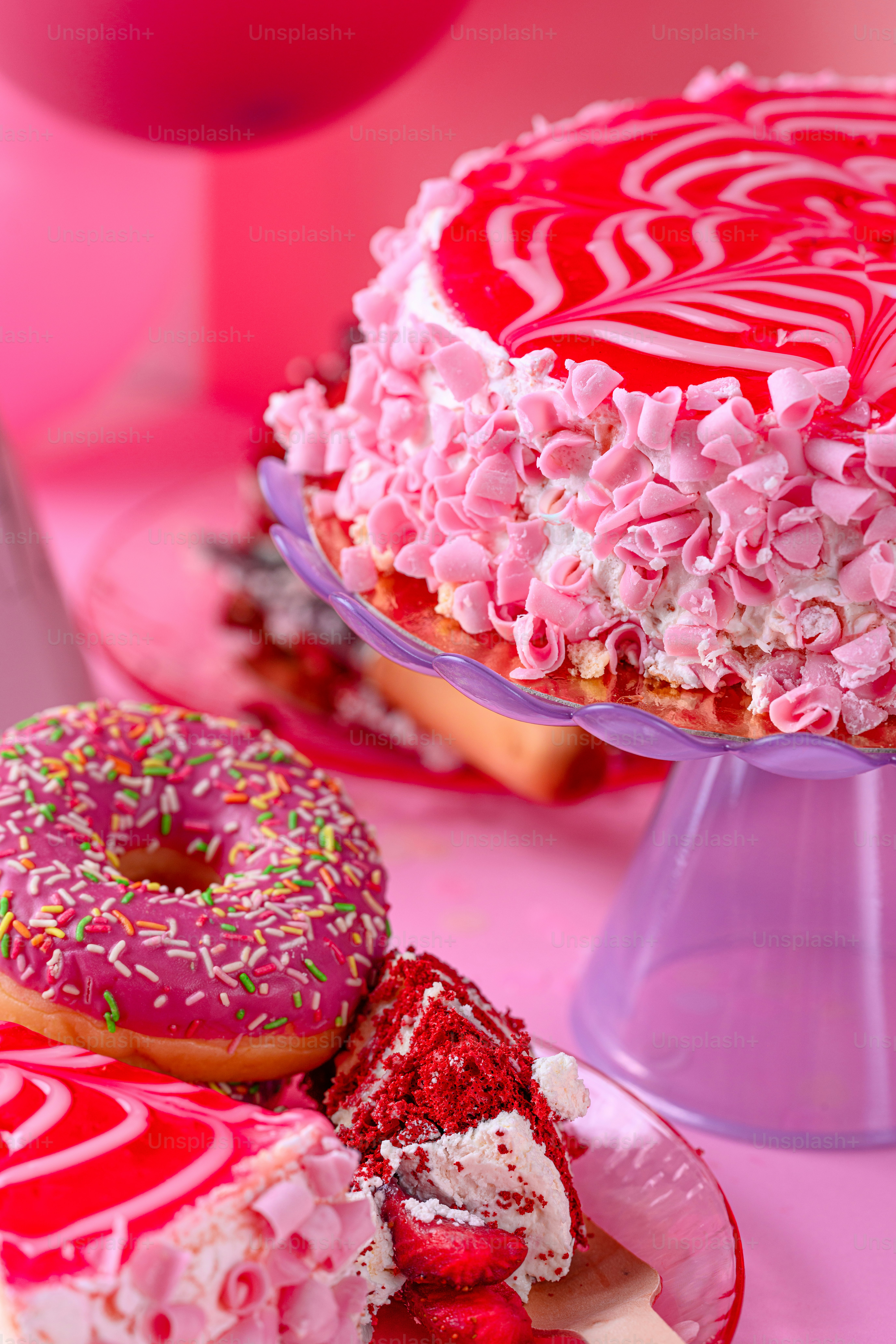 A pink cake with white frosting and sprinkles photo – Birthday cake ...