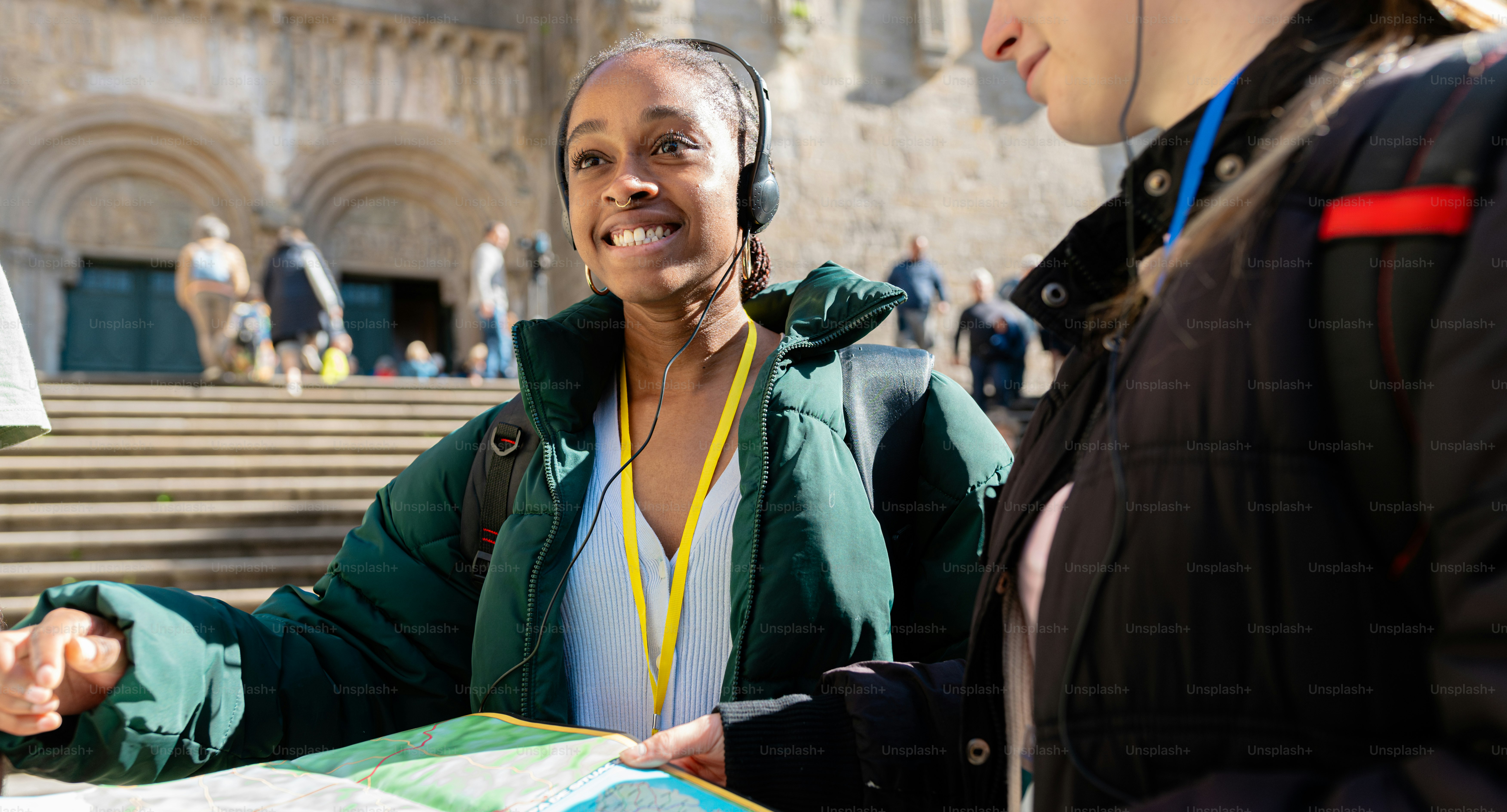 a woman with headphones on talking to another woman