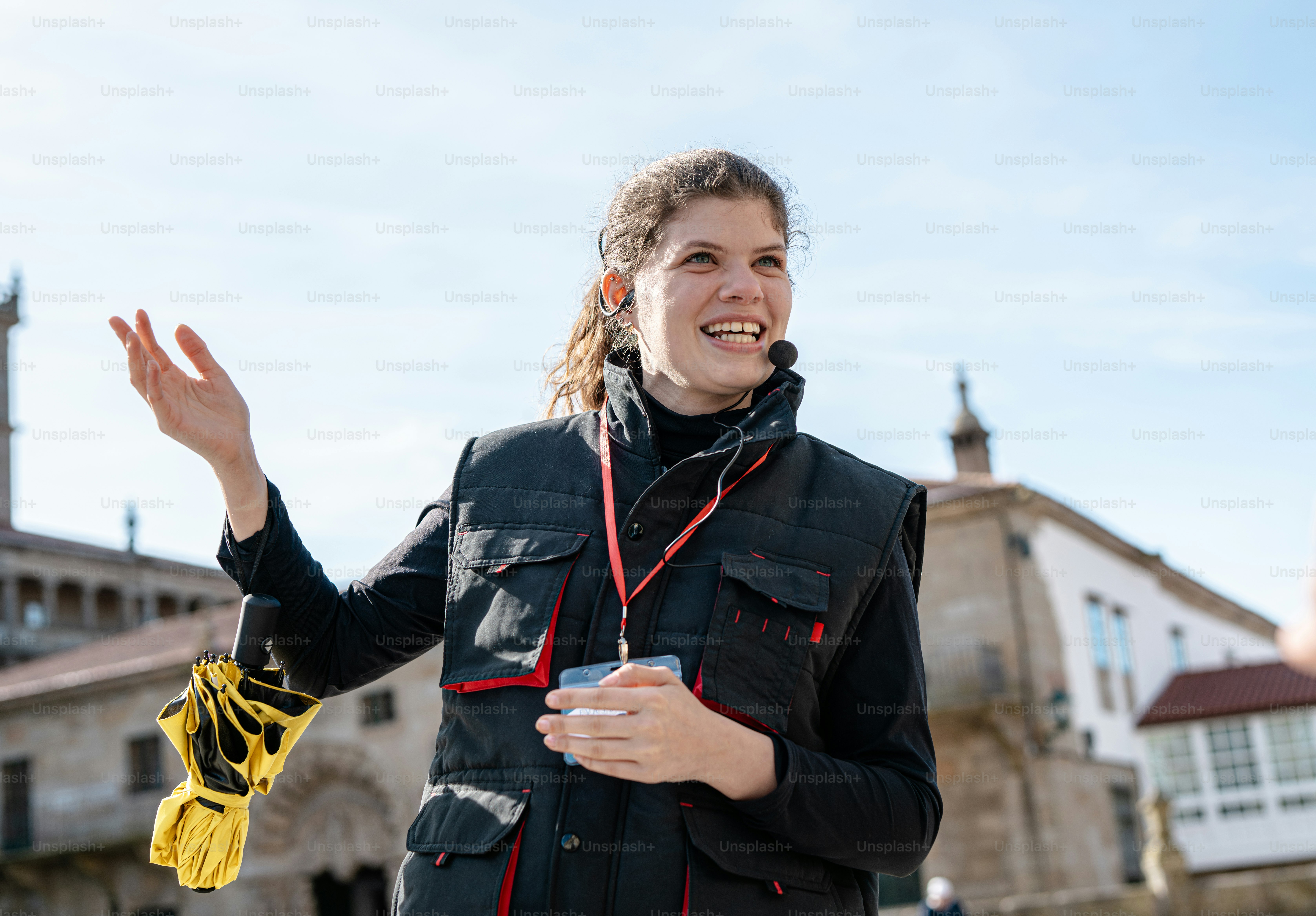 a woman standing in front of a building holding a cell phone