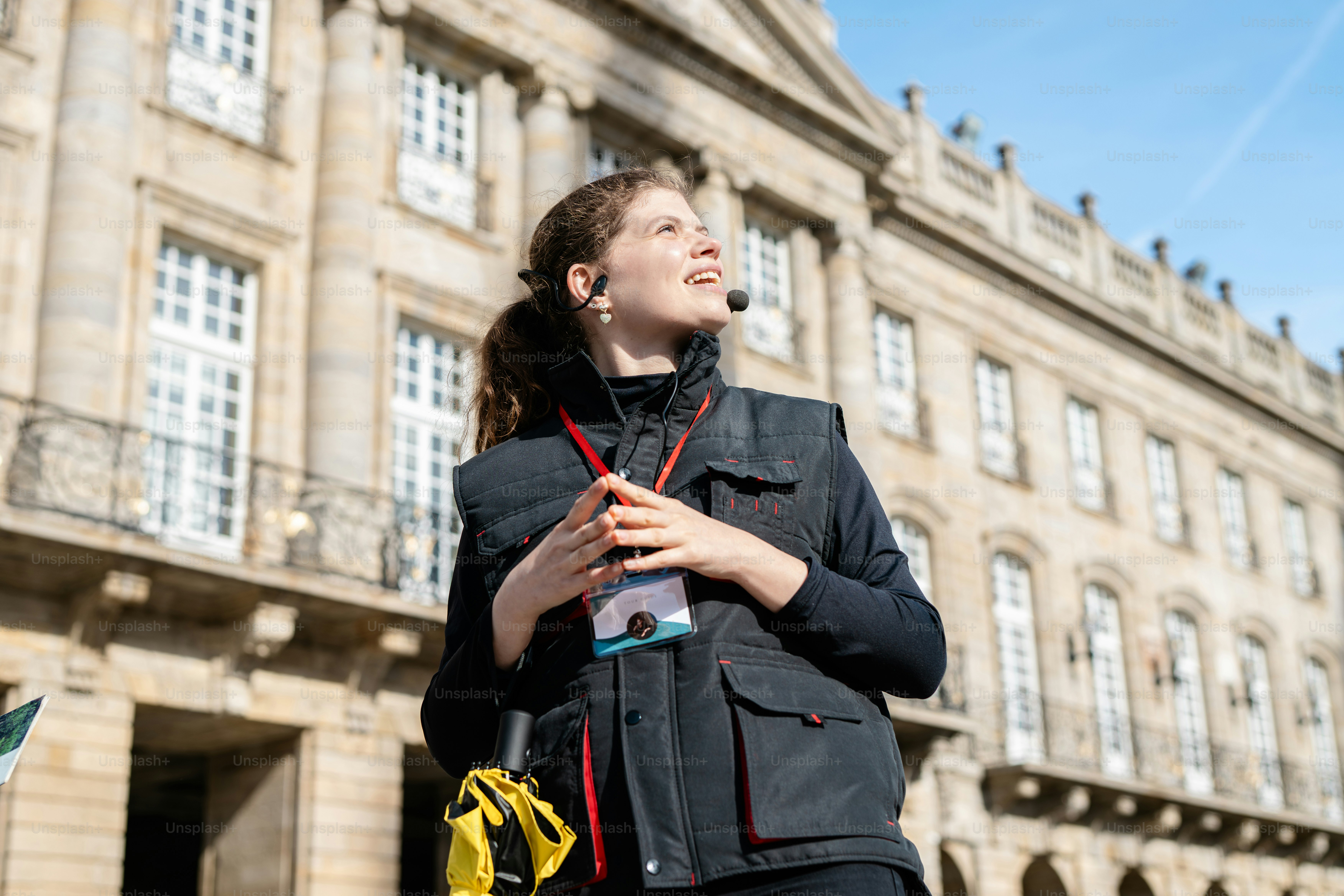 a woman standing in front of a large building