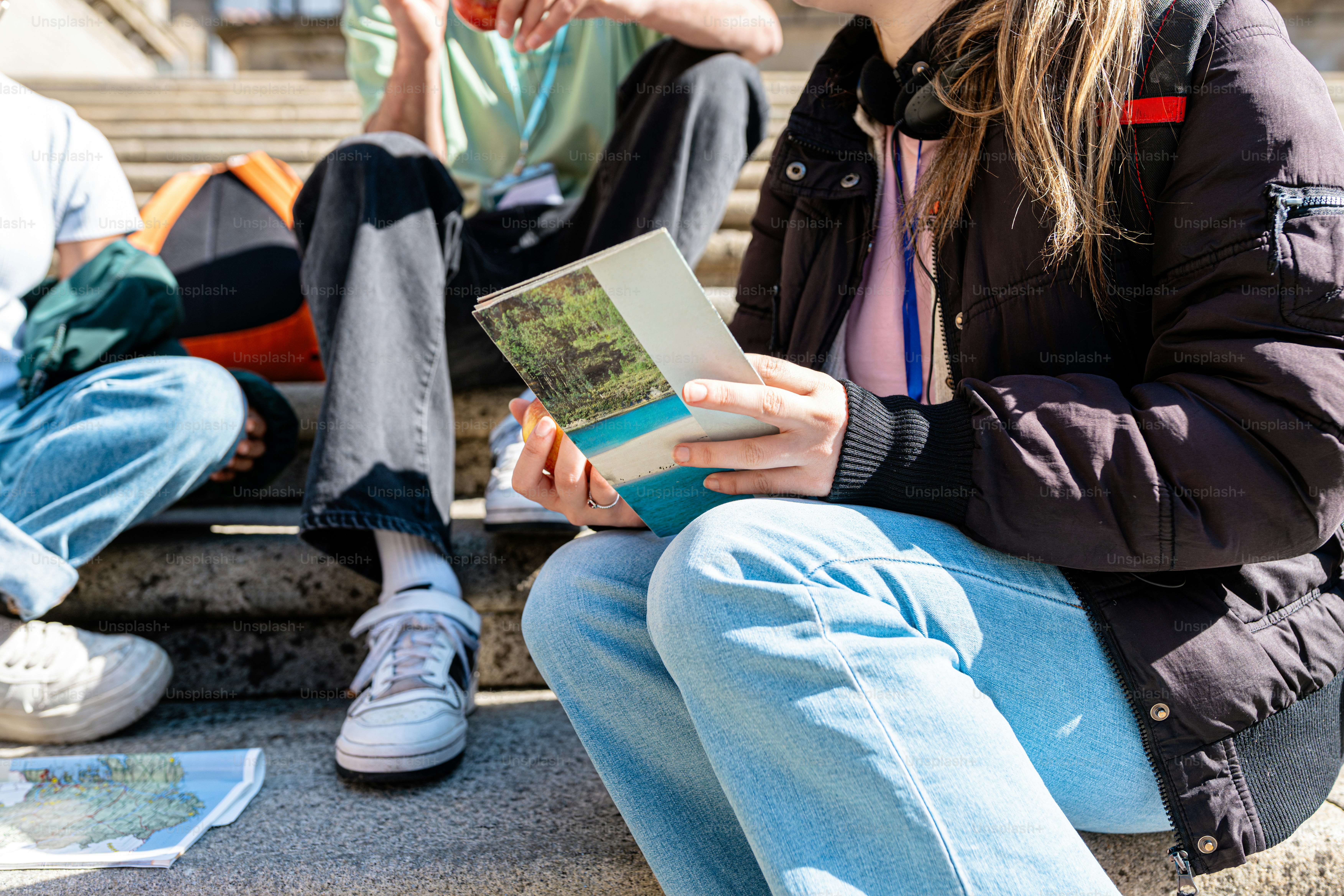 a group of people sitting on the steps of a building