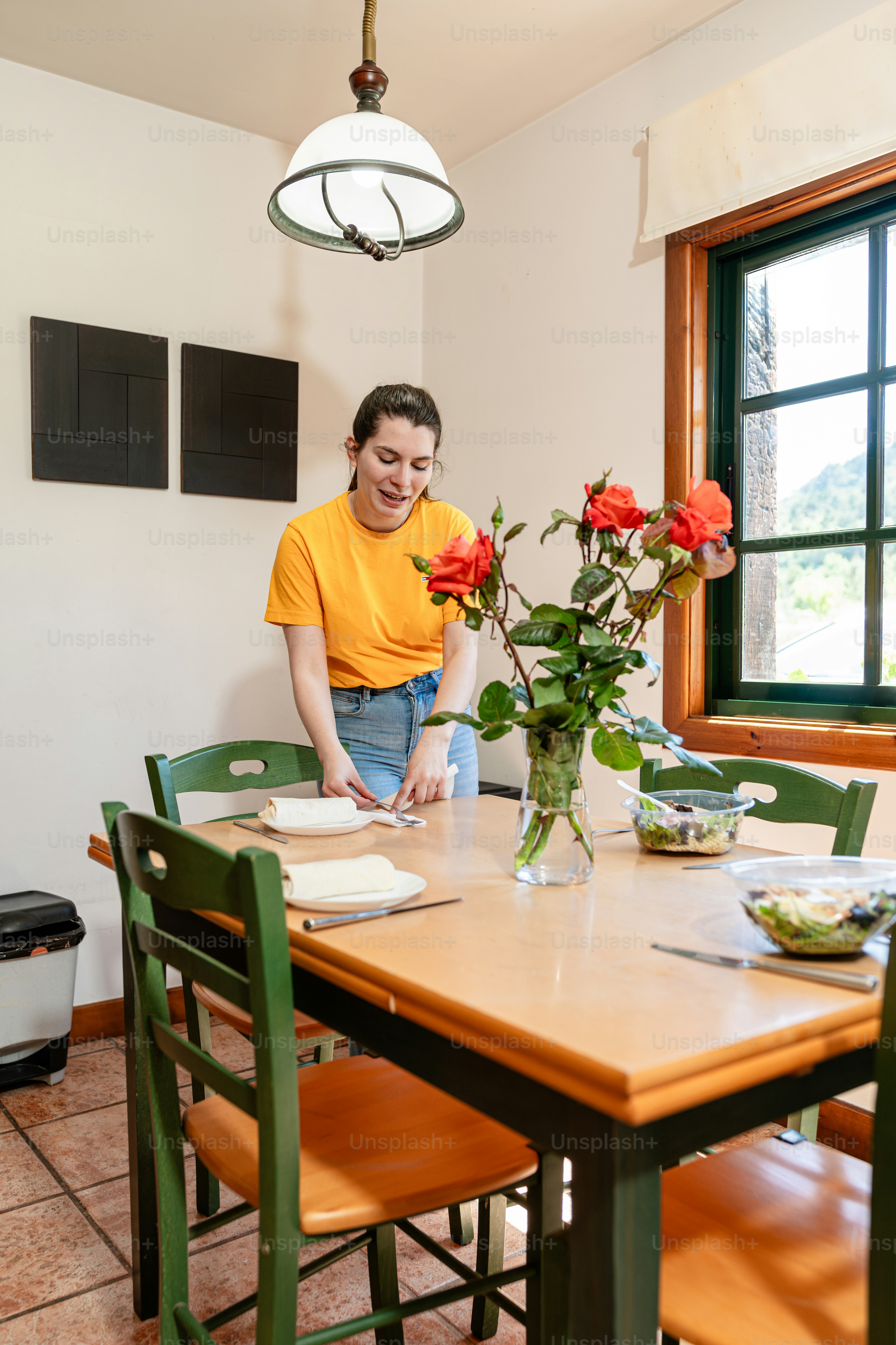 a man sitting at a table with flowers in a vase