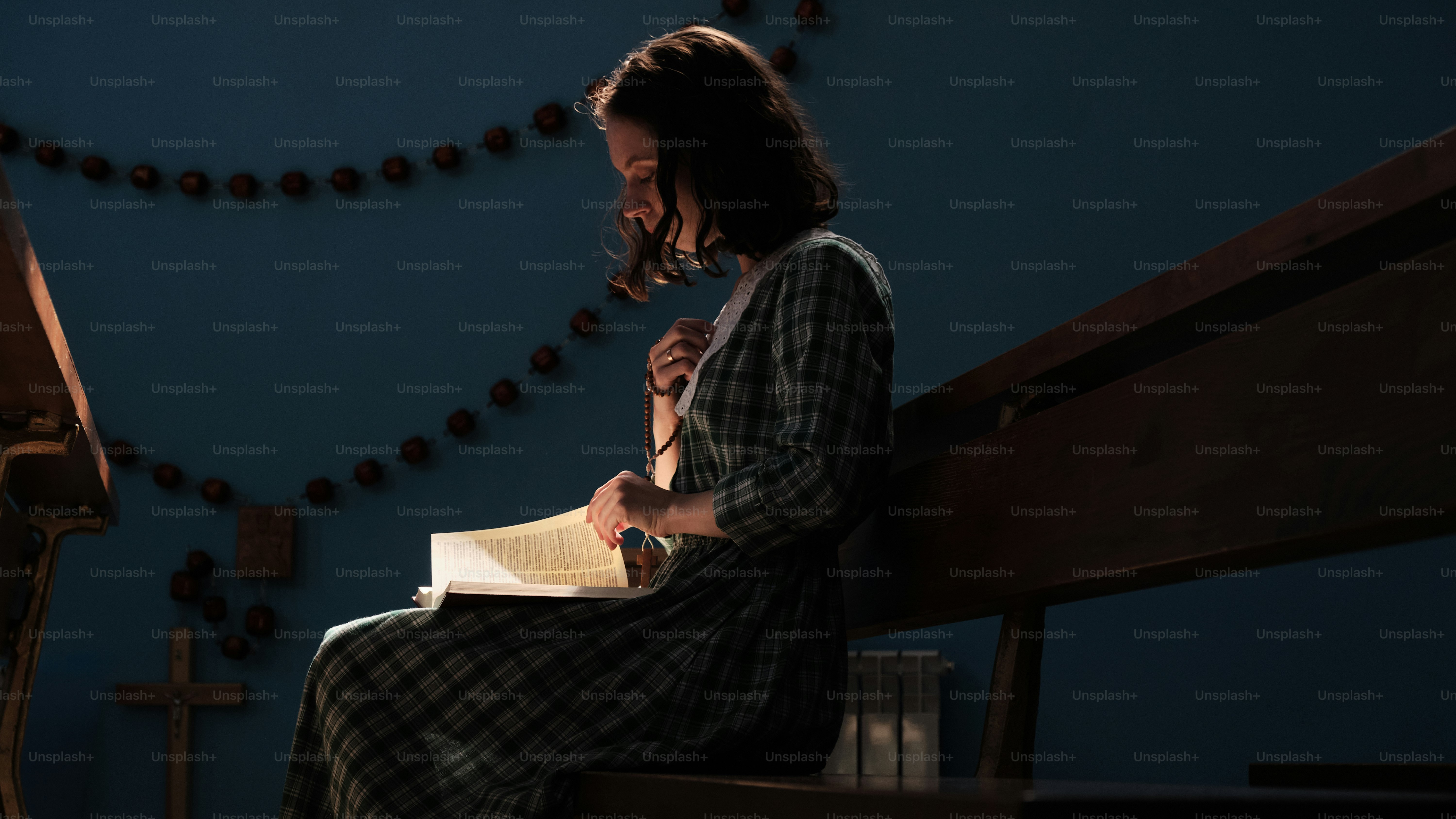 a woman sitting on a bench reading a book