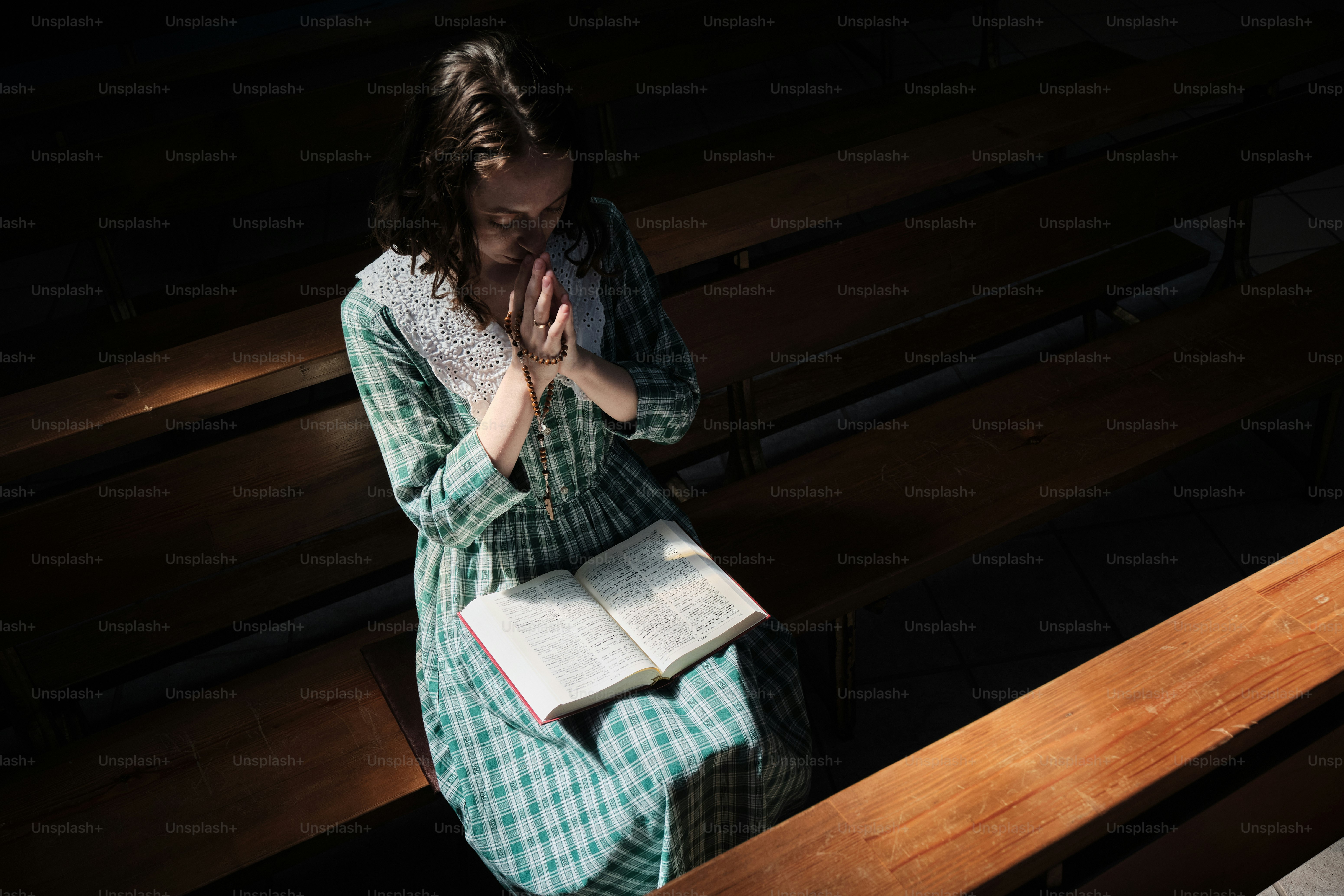 a woman sitting on a bench reading a book