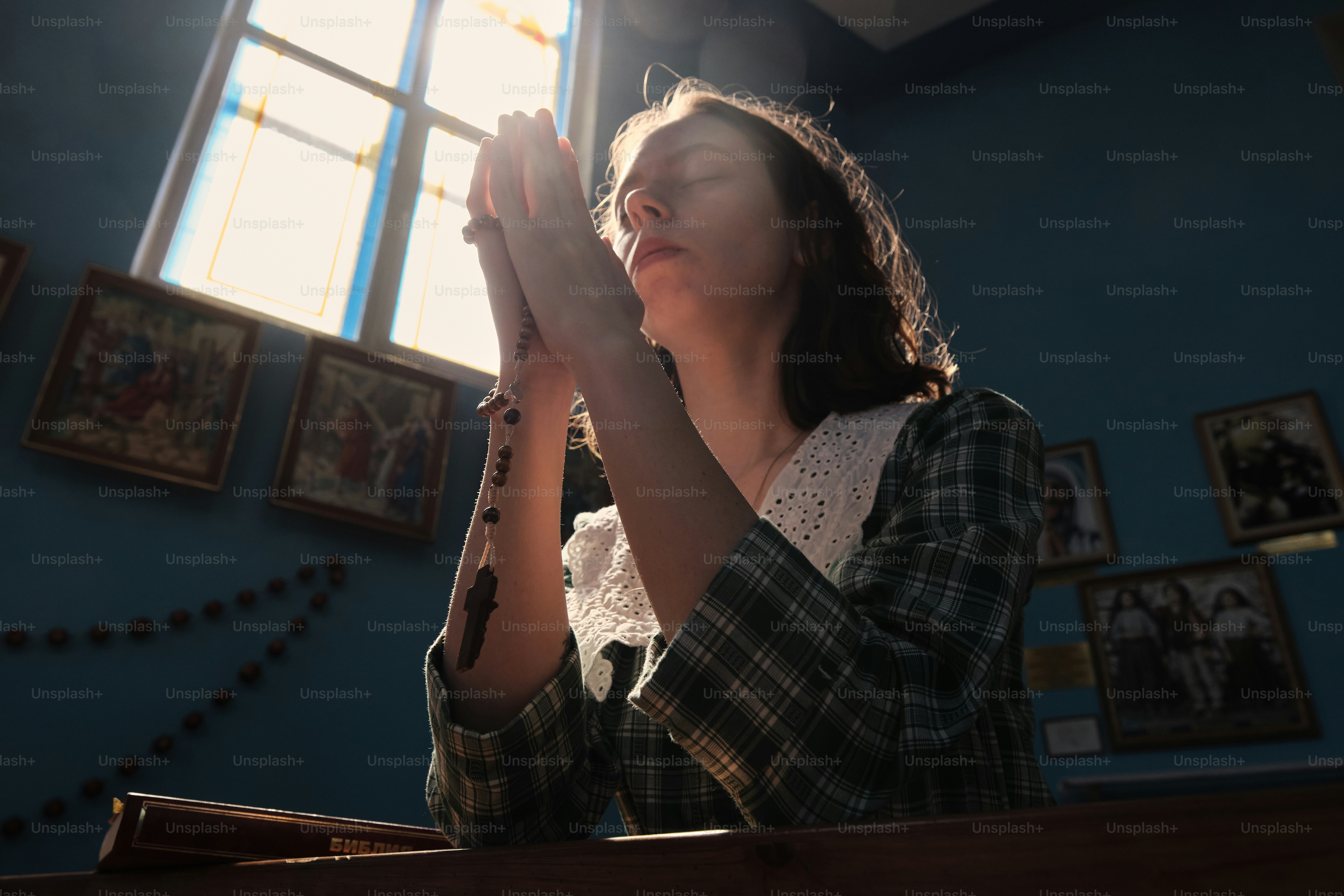 a woman is praying in a church