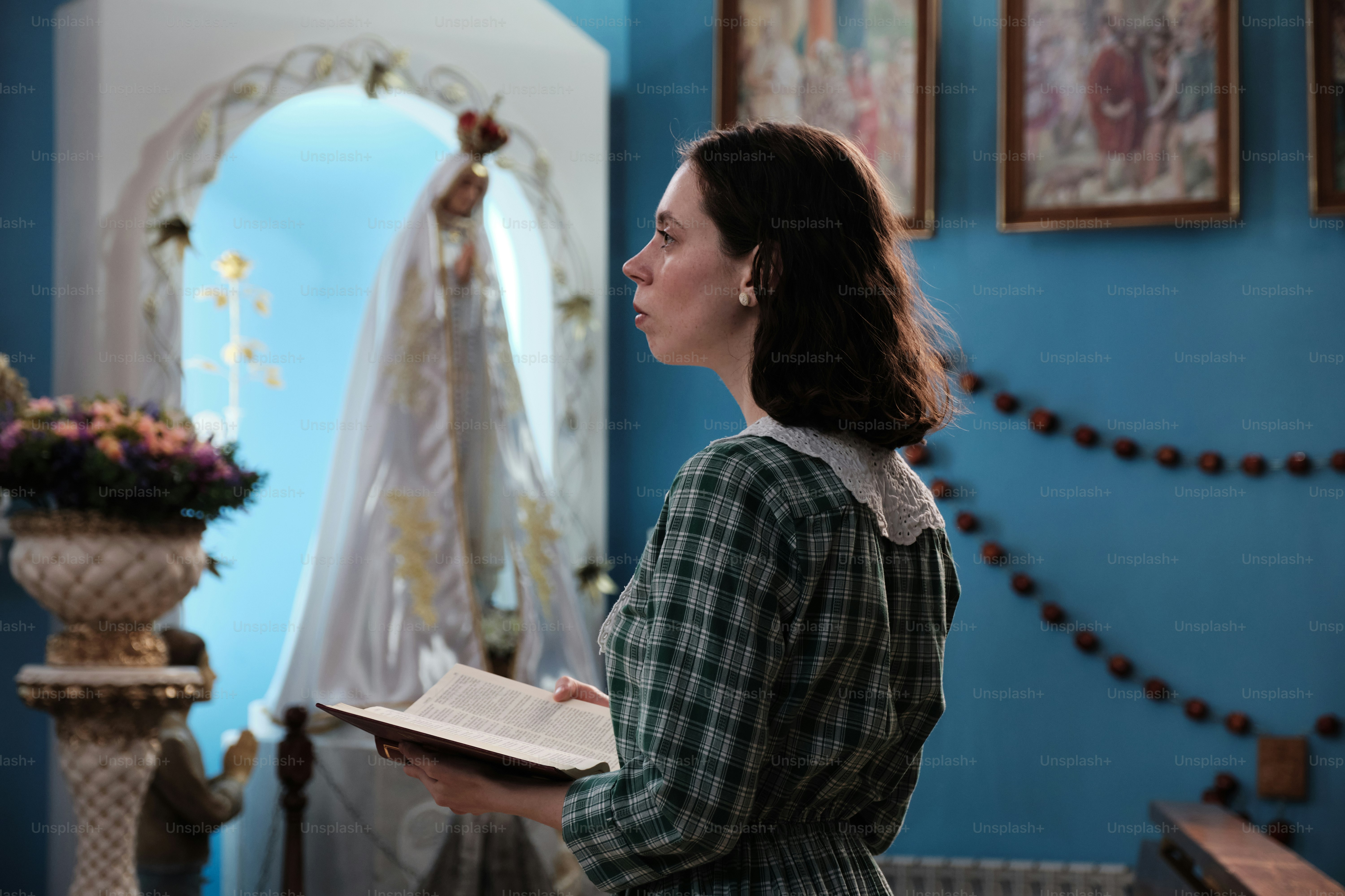 a woman standing in a room holding a book