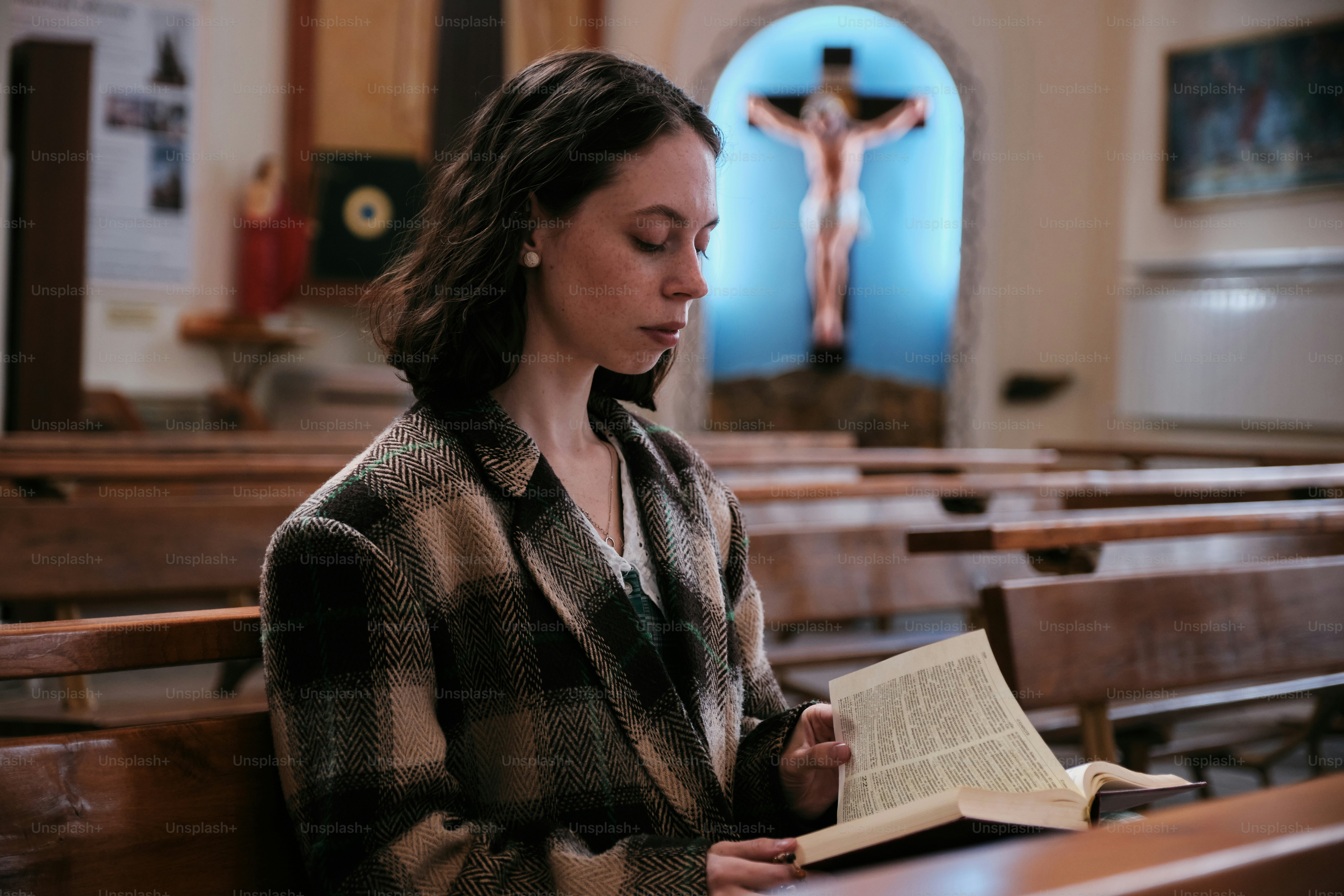 a woman reading a book in a church